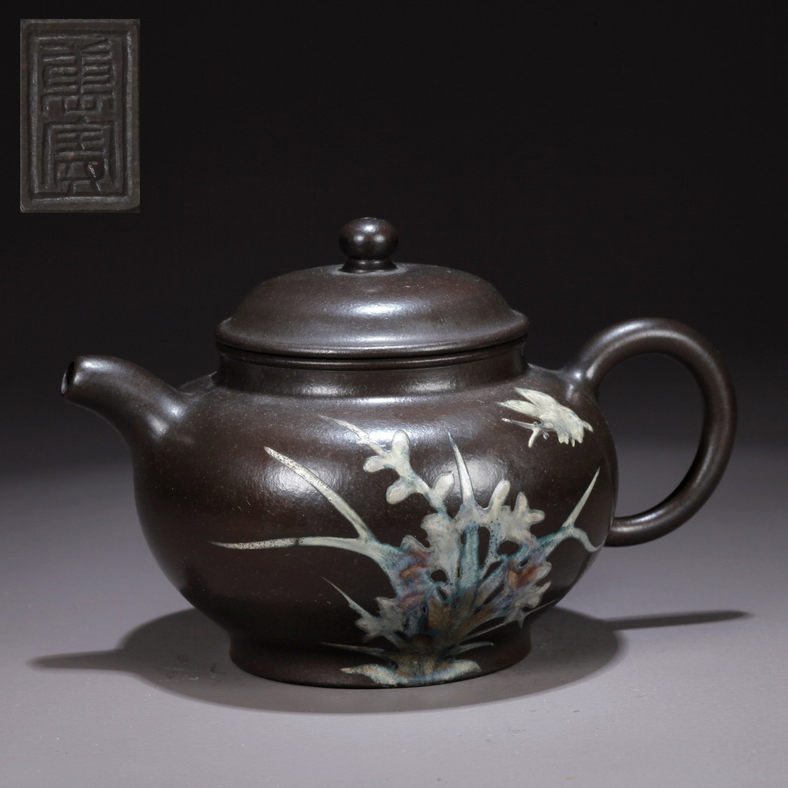 A PURPLE CLAY (ZISHA) TEAPOT WITH FLOWER-AND-BUTTERFLY MOTIF: Purple Clay (Zisha) Teapot with Flower-and-Butterfly Motif