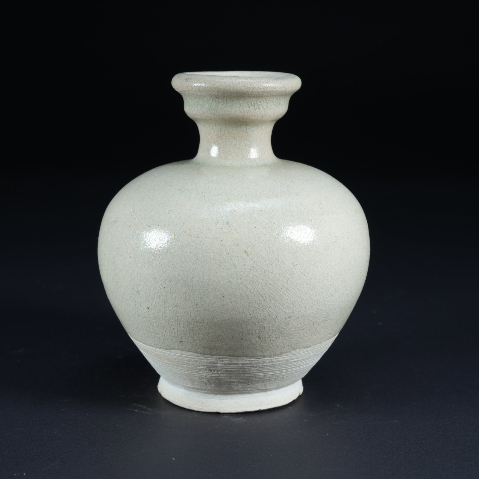 A WHITE-GLAZED SMALL BOTTLE WITH FLARED MOUTH: White-Glazed Small Bottle with Flared Mouth