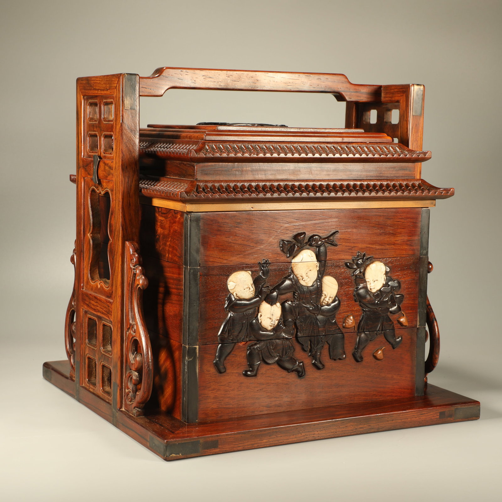 A HUANGHUALI PORTABLE BOX INLAID WITH RED SANDALWOOD HORN CARVING OF CHILDREN AT PLAY FIGURES: Huanghuali Portable Box Inlaid with Red Sandalwood Horn Carving of Children at Play Figures