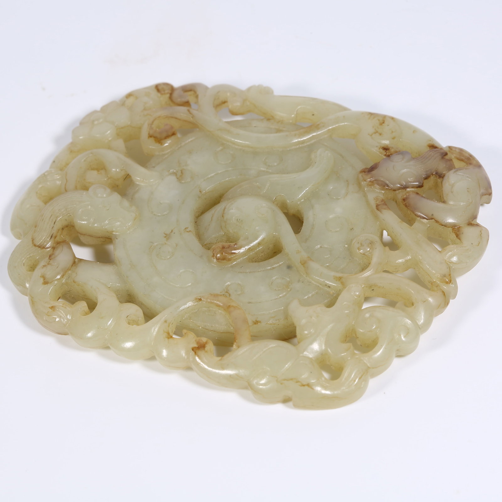 A ANCIENT JADE BI DISK WITH DOUBLE DRAGON AND EXPANDED RIM MOTIF (1 of 9)