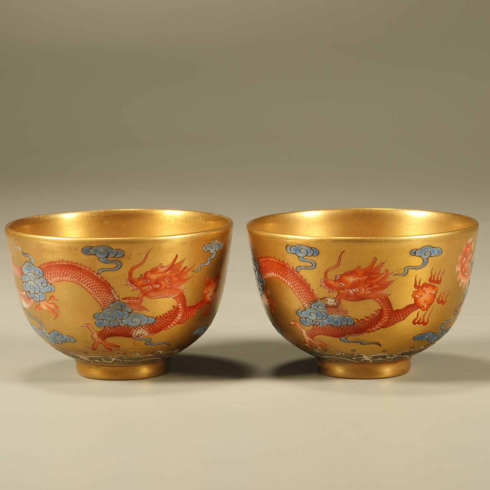 A PAIR OF IRON-RED GILT CUPS WITH DRAGON AND PHOENIX PATTERN: Pair of Iron-red Gilt Cups with Dragon and Phoenix Pattern