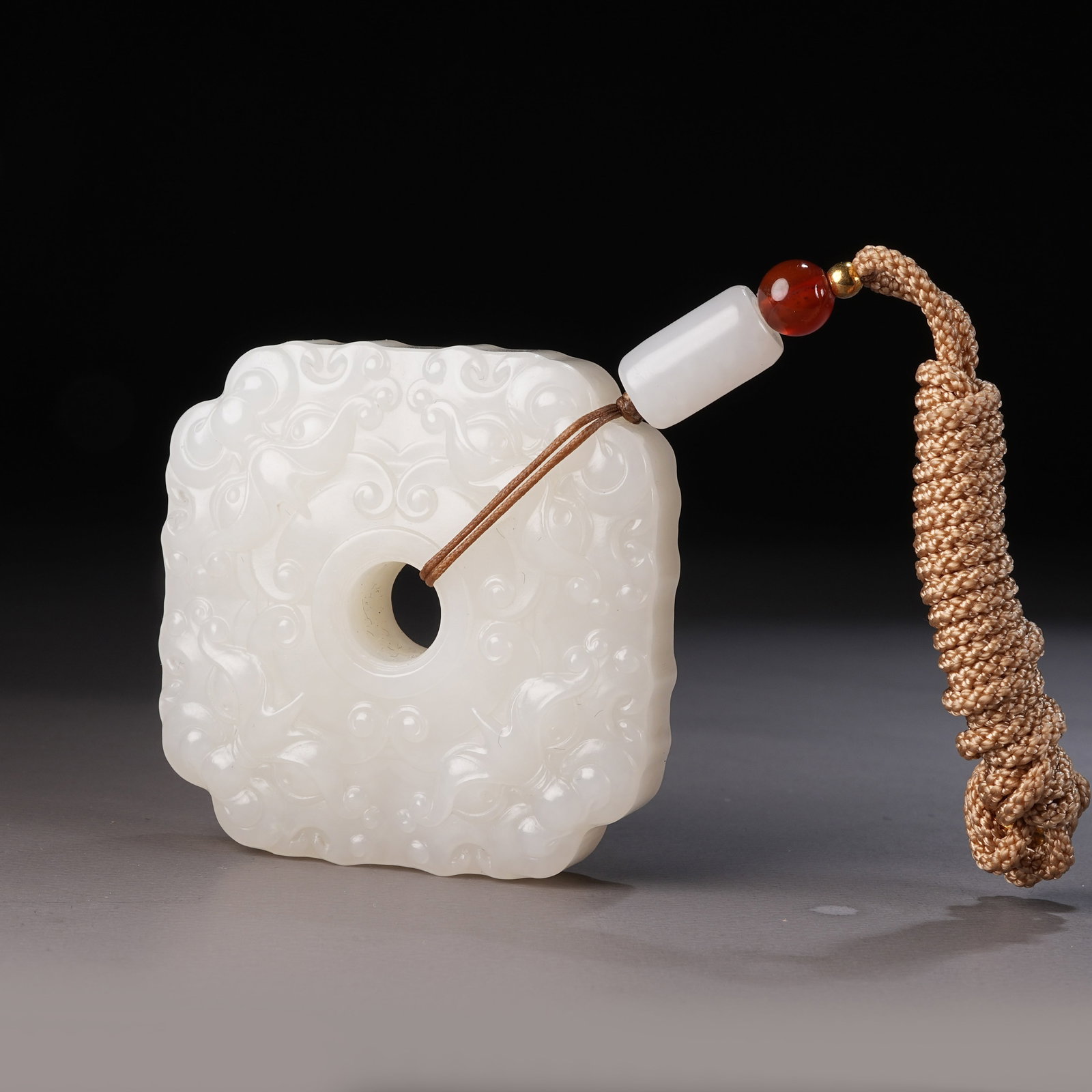 A HETIAN WHITE JADE PENDANT WITH BEAST-MASK MOTIF: Hetian White Jade Pendant with Beast-Mask Motif