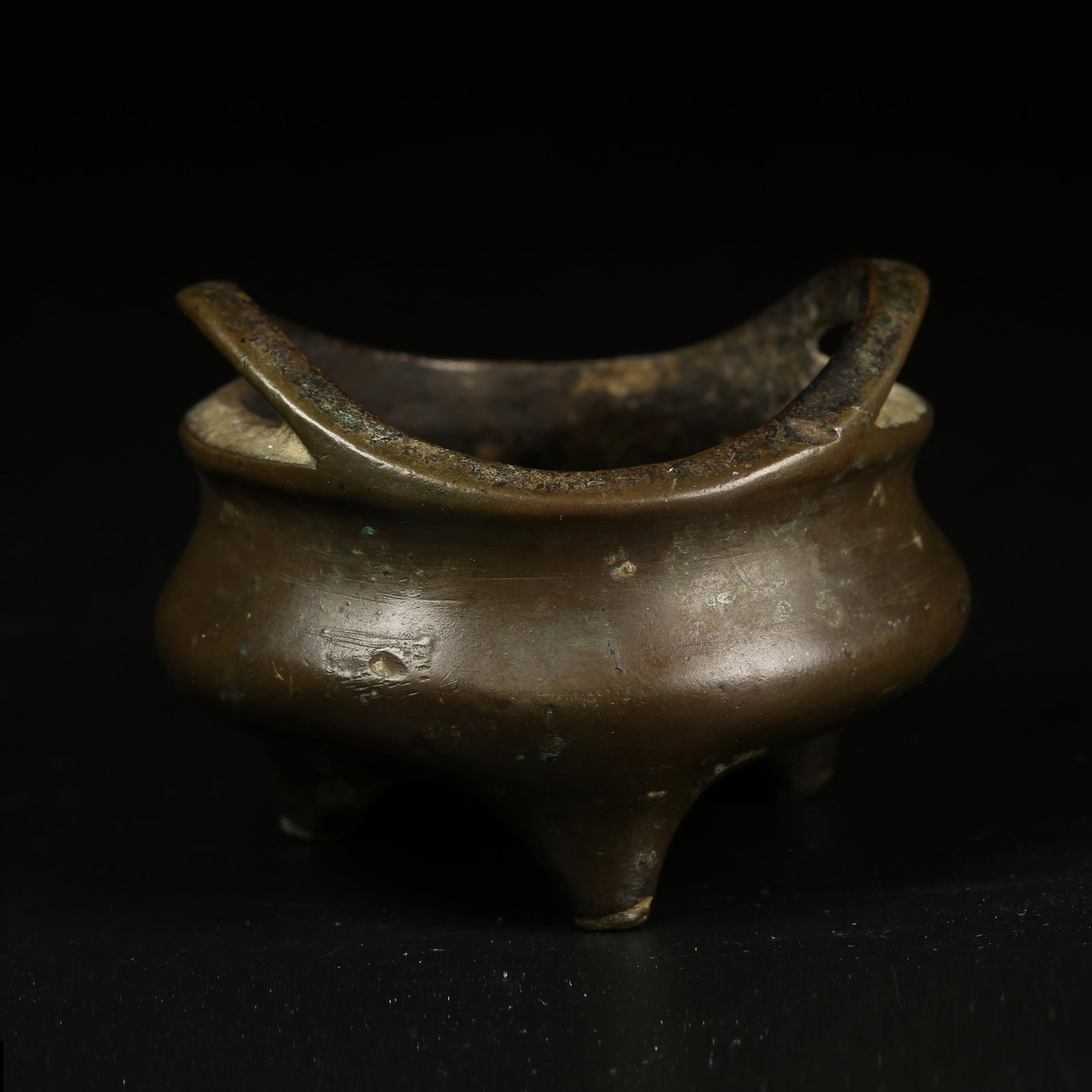 A BRONZE TRIPOD CENSER WITH LOOP HANDLES: Bronze Tripod Censer with Loop Handles