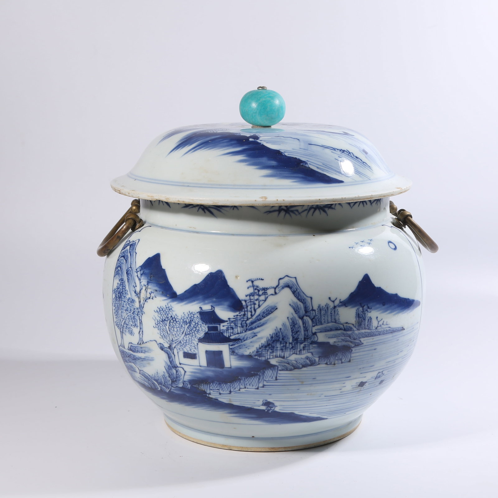 A BLUE-AND-WHITE LANDSCAPE JAR WITH INLAID GEMS AND BRONZE HANDLES: Blue-and-White Landscape Jar with Inlaid Gems and Bronze Handles