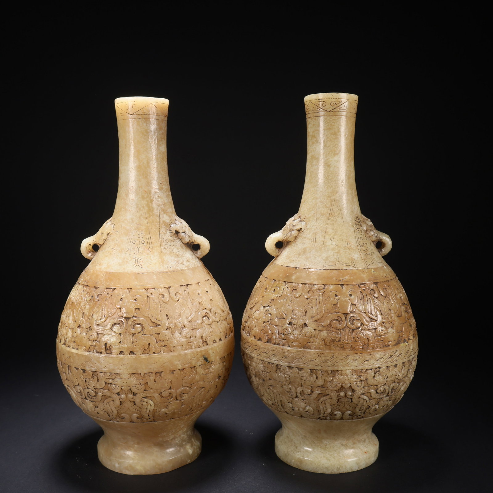 A HETIAN JADE TWISTED-DRAGON PATTERN LONG-NECK BOTTLE (PAIR): Hetian Jade Twisted-Dragon Pattern Long-Neck Bottle (pair)