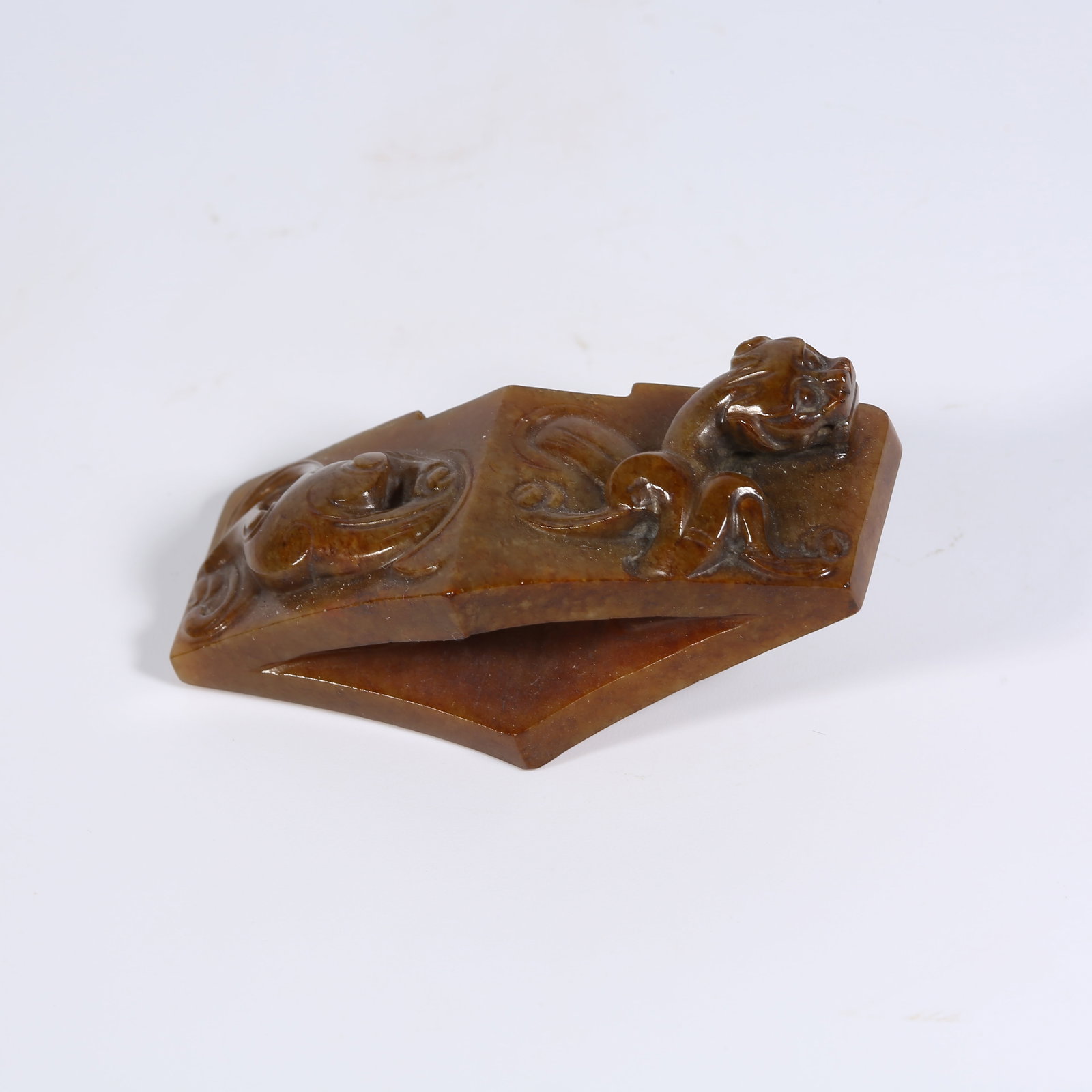 A ANCIENT JADE SWORD GUARD WITH SCROLL CLOUD MOTIF: Ancient Jade Sword Guard with Scroll Cloud Motif
