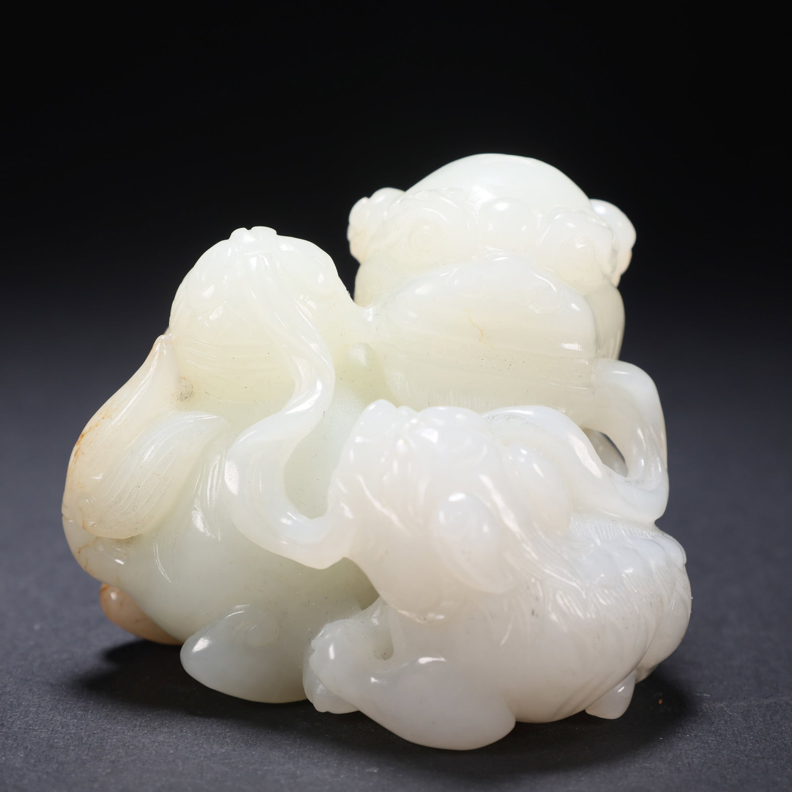 A HETIAN JADE CONTRASTING COLOR DOUBLE LIONS ROLLING SNOWBALL: Hetian Jade Contrasting Color Double Lions Rolling Snowball