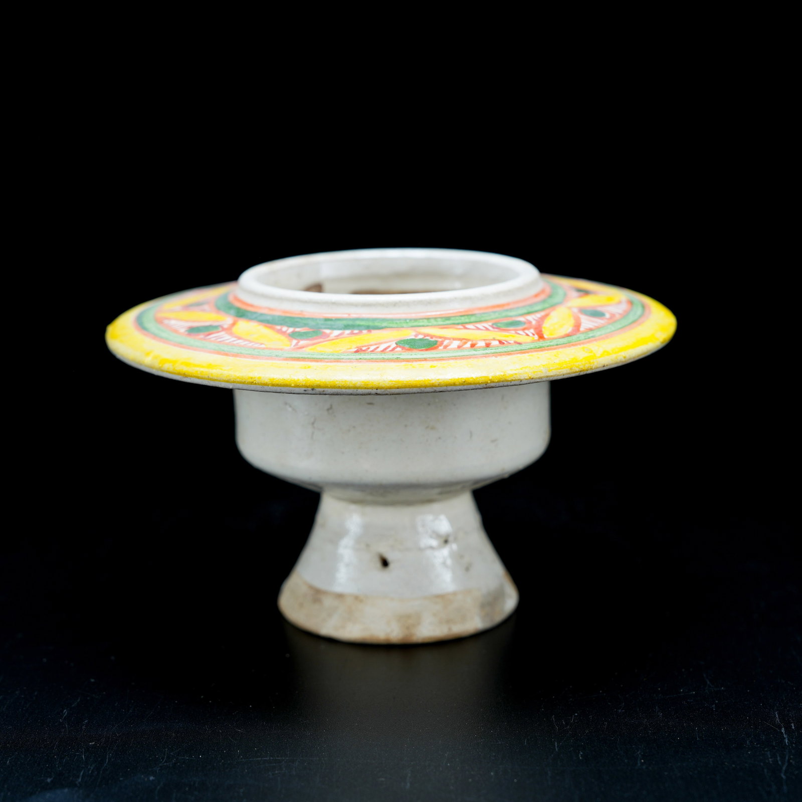 A TANG SANCAI FOLDED-RIM CANDLESTICK: Tang Sancai Folded-Rim Candlestick