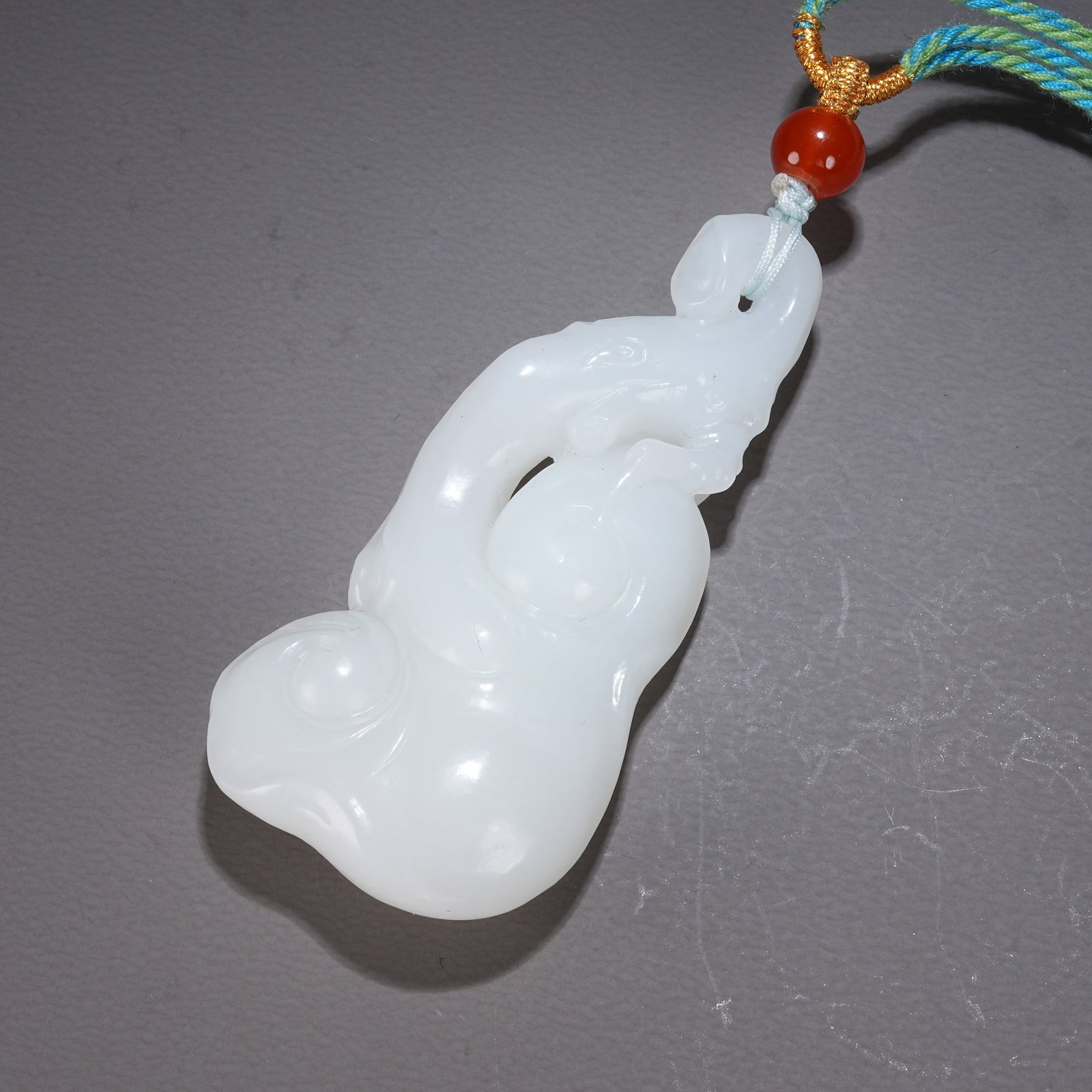 A HETIAN WHITE JADE "RUYI" PENDANT WITH AUSPICIOUS CLOUD MOTIFS (1 of 8)