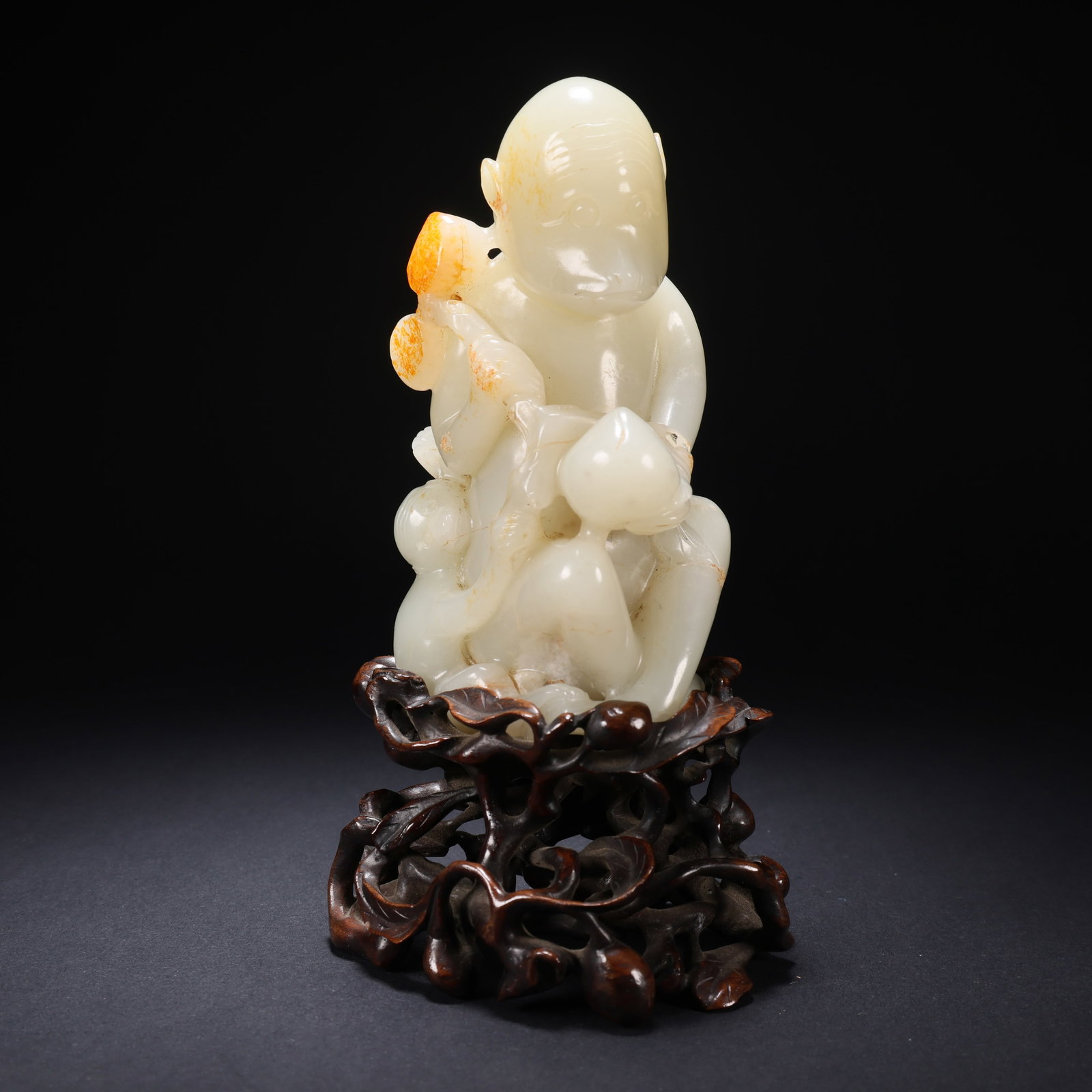 A HETIAN JADE MOTHER-AND-CHILD MONKEYS ON WOODEN BASE IN CONTRASTING COLOR: Hetian Jade Mother-and-Child Monkeys on Wooden Base in Contrasting Color