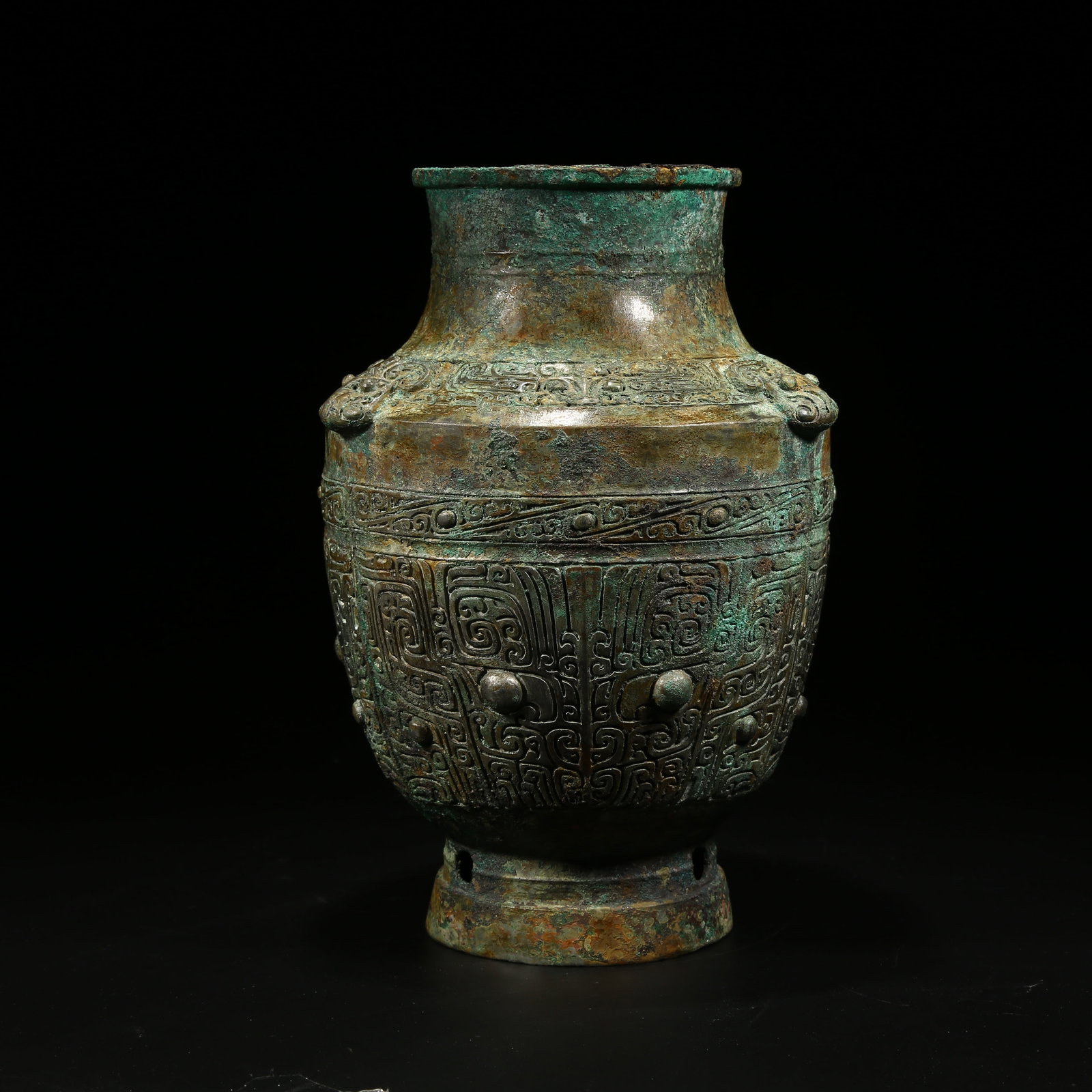 A BRONZE ZUN VESSEL WITH TAOTIE (BEAST FACE) PATTERN: Bronze zun vessel with taotie (beast face) pattern