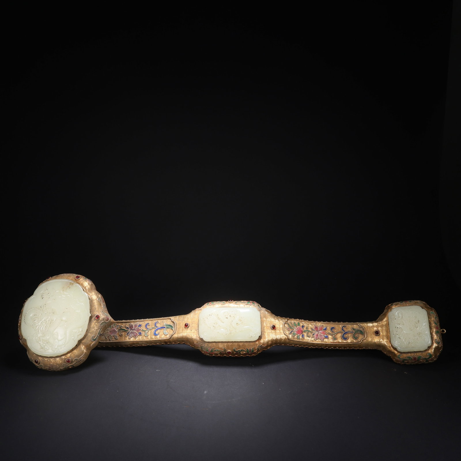 A HETIAN JADE GILT-BRONZE CLOISONNÉ GEM-INLAID "TWO DRAGONS, ONE PHOENIX" RUYI: Hetian Jade Gilt-Bronze Cloisonné Gem-Inlaid "Two Dragons, One Phoenix" Ruyi