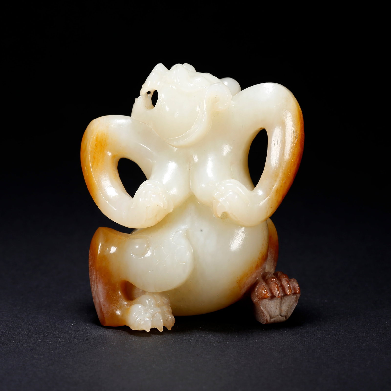 A HETIAN JADE BEAST-SHAPED FIGURINE: Hetian Jade Beast-Shaped Figurine