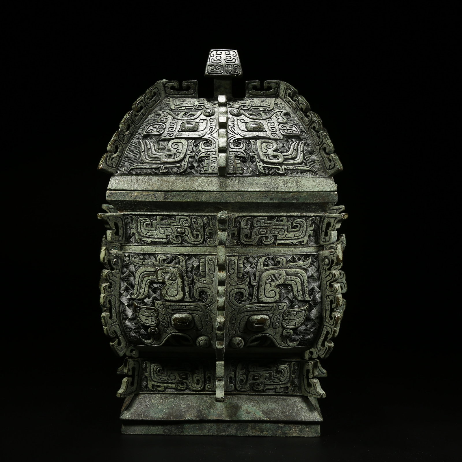 A BRONZE YI VESSEL WITH TAOTIE (BEAST FACE) PATTERN (1 of 11)
