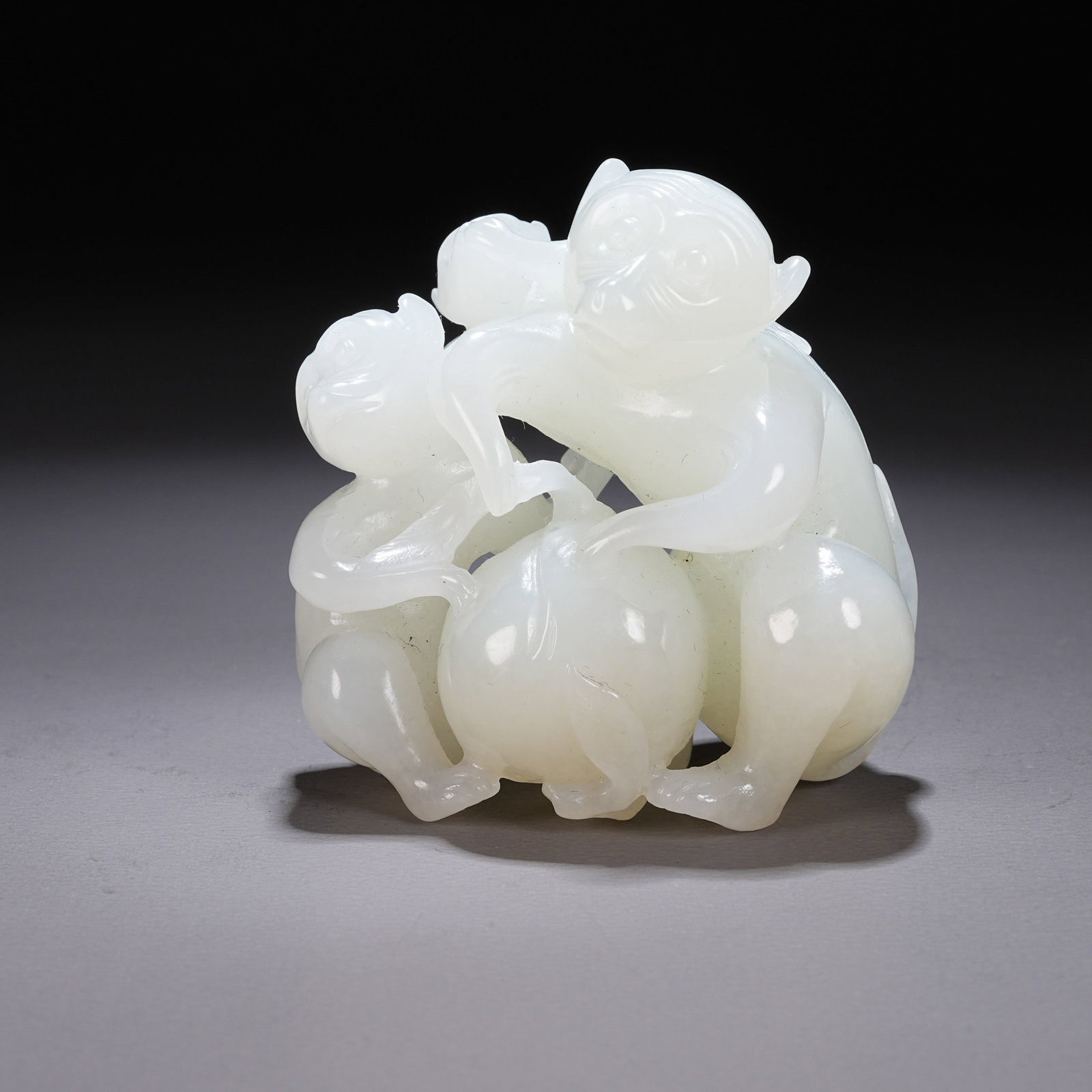 A HETIAN WHITE JADE "MONKEY PRESENTING LONGEVITY" ORNAMENT (1 of 8)