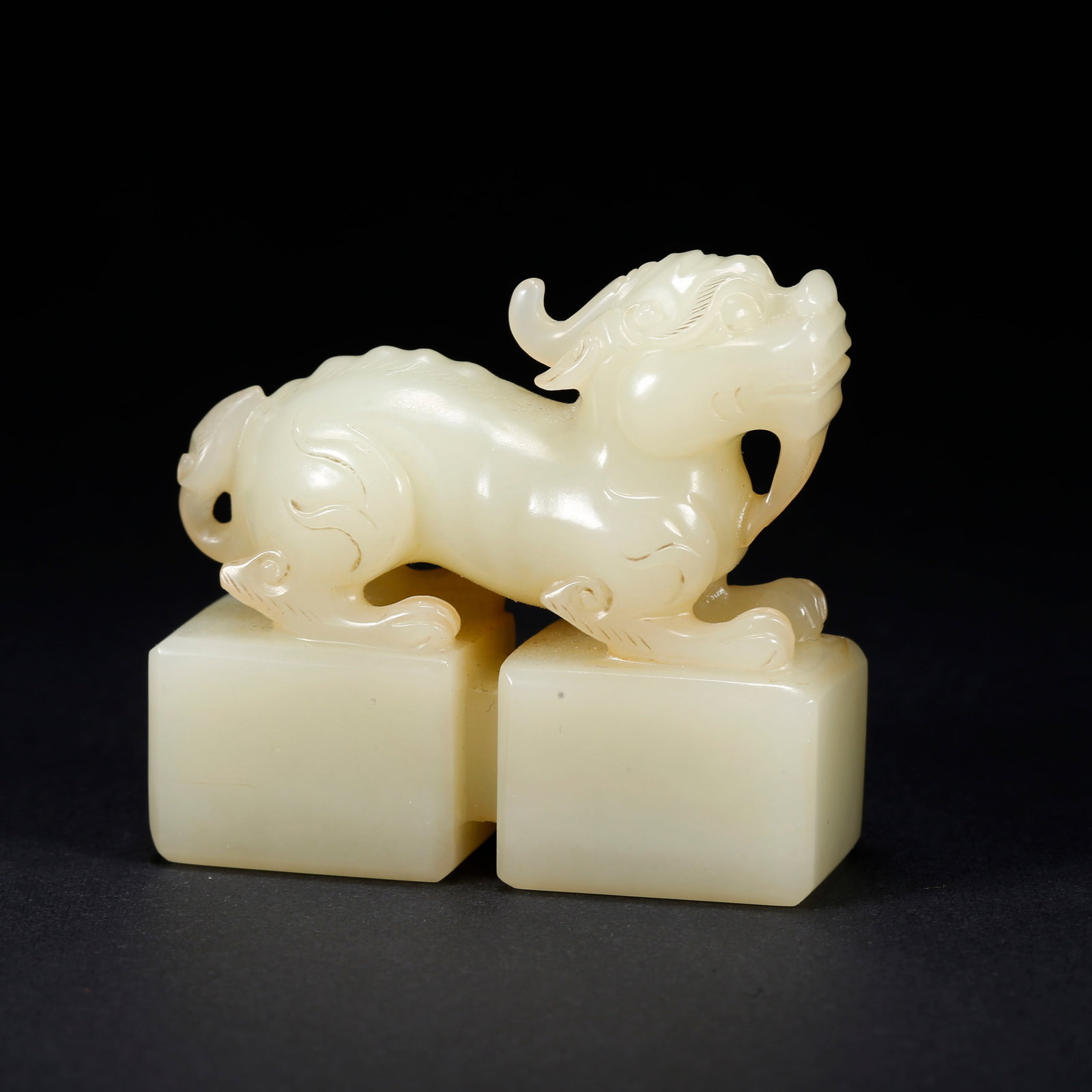 A HETIAN JADE DOUBLE-LINKED BEAST SEAL PAPERWEIGHT (1 of 9)