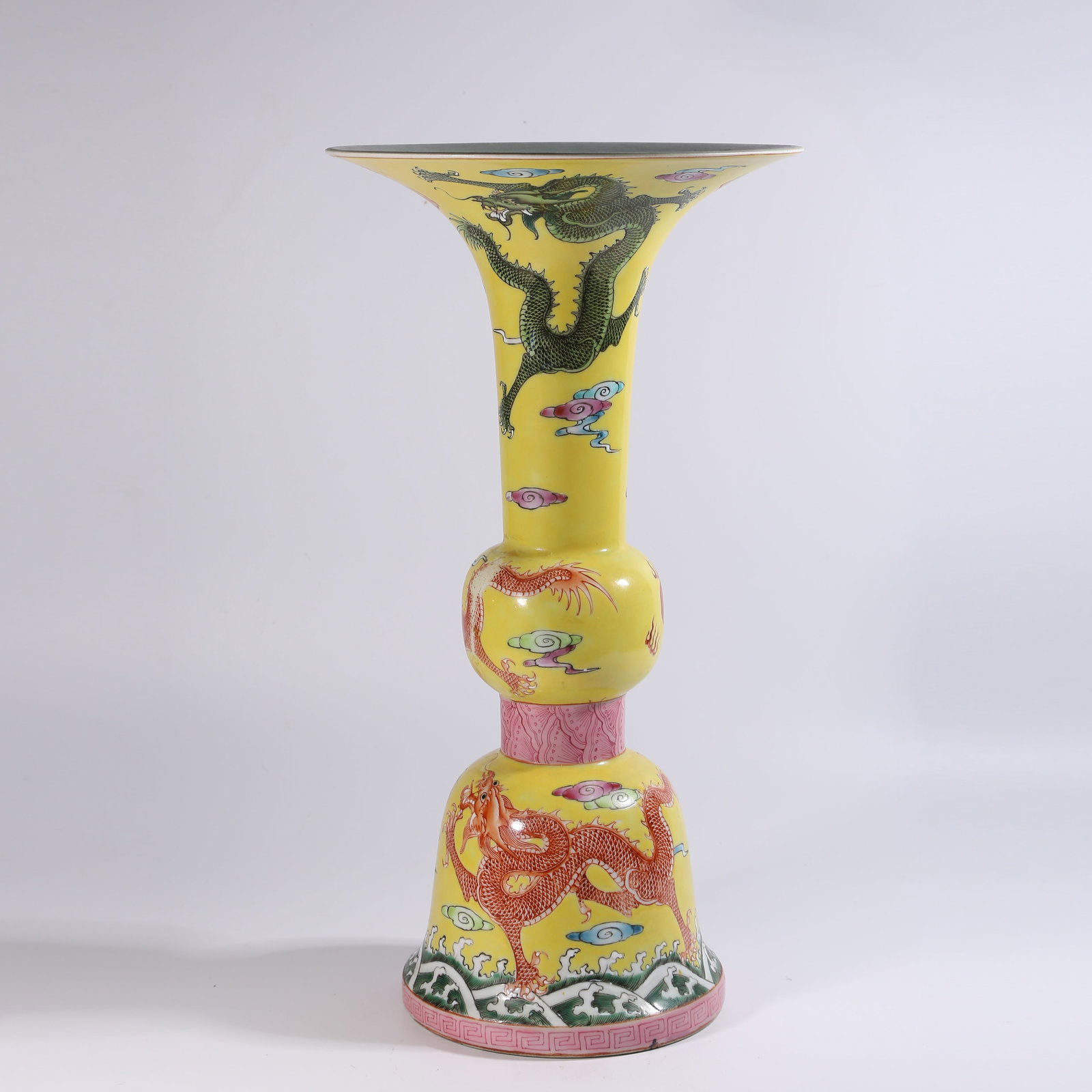 A YELLOW-GROUND FENCAI FLOWER GU WITH CLOUD-AND-DRAGON PATTERN: Yellow-Ground Fencai Flower Gu with Cloud-and-Dragon Pattern