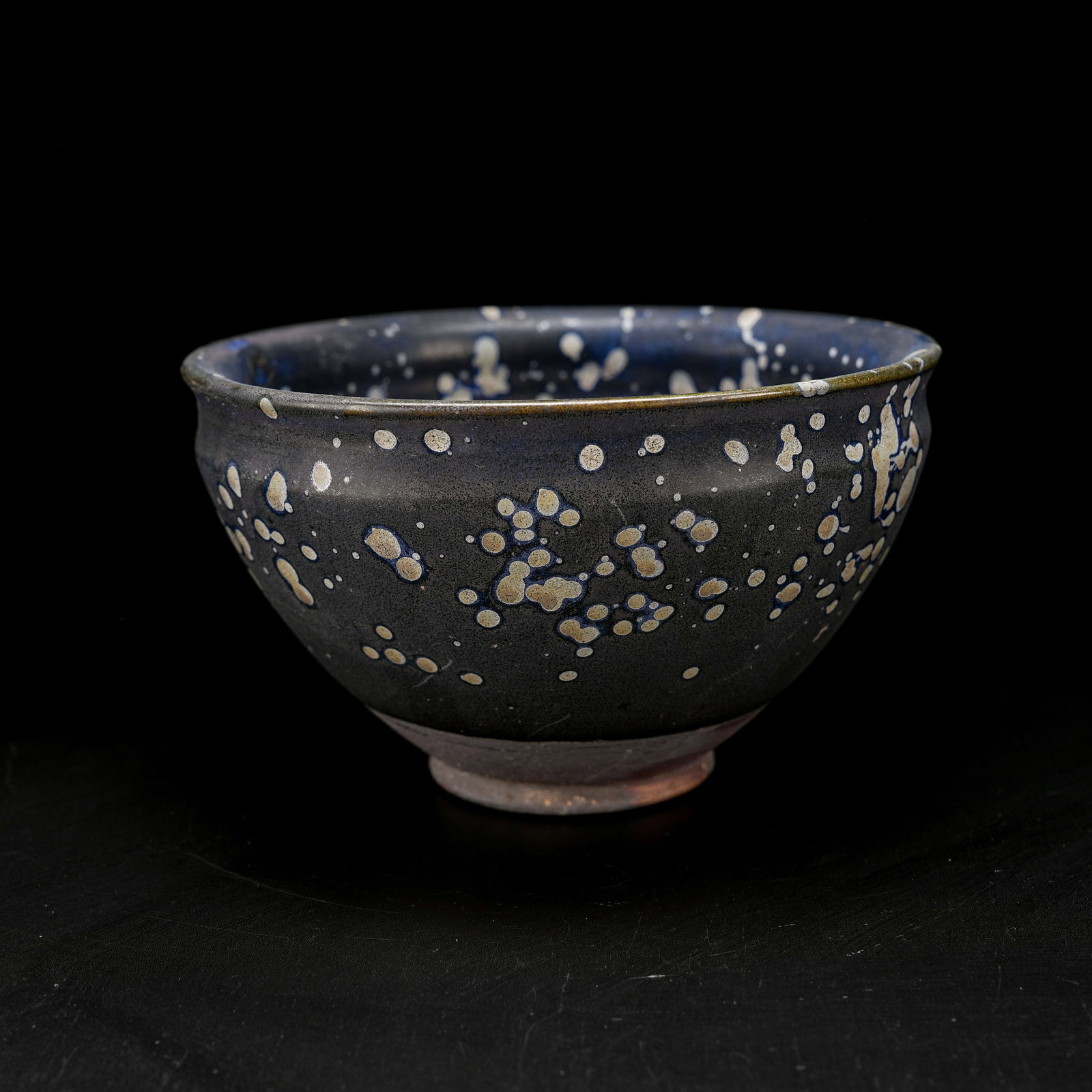 A BLACK GLAZED PARTRIDGE-SPOTTED TEA CUP: Black Glazed Partridge-Spotted Tea Cup