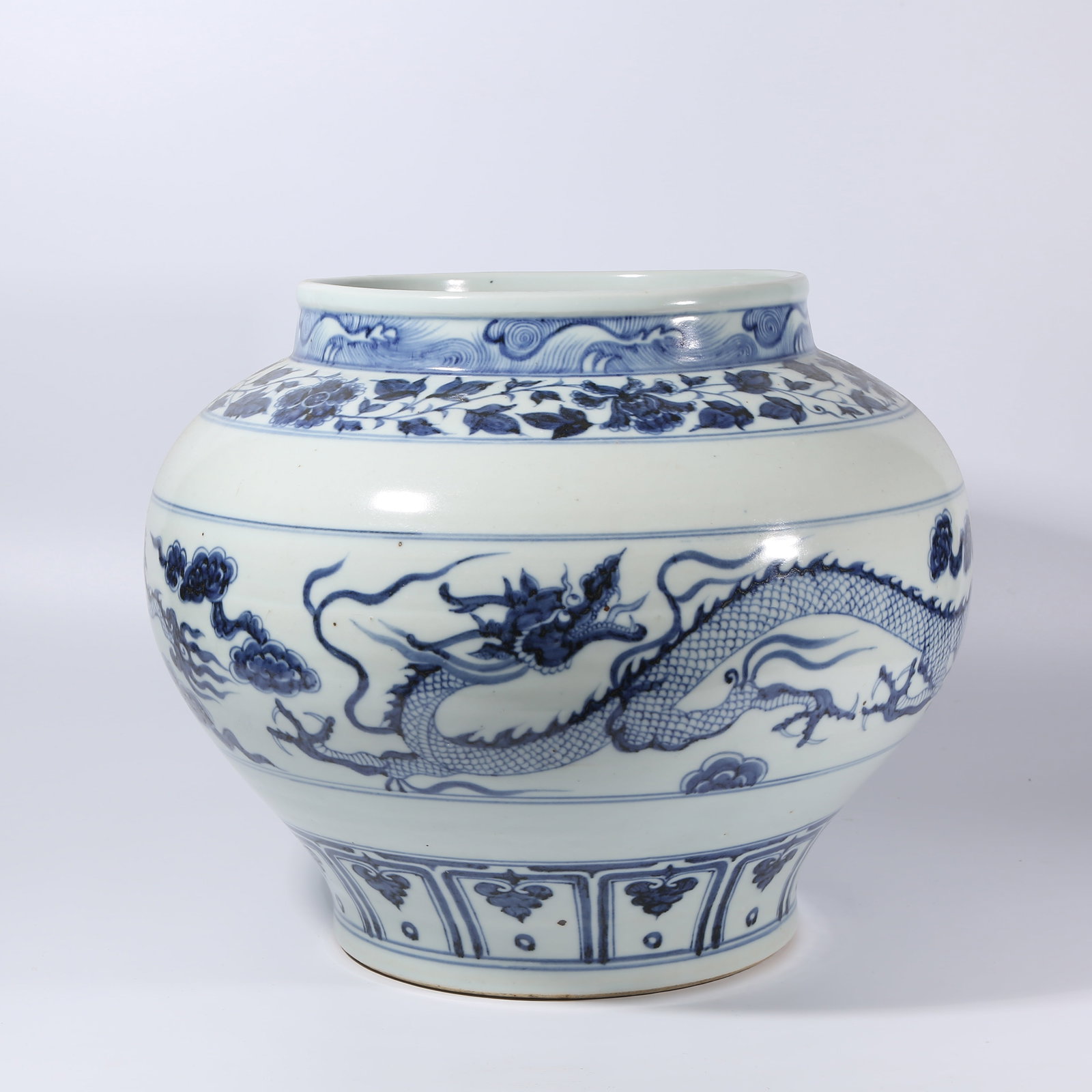 A BLUE-AND-WHITE CLOUD AND DRAGON PATTERN JAR: Blue-and-White Cloud and Dragon Pattern Jar
