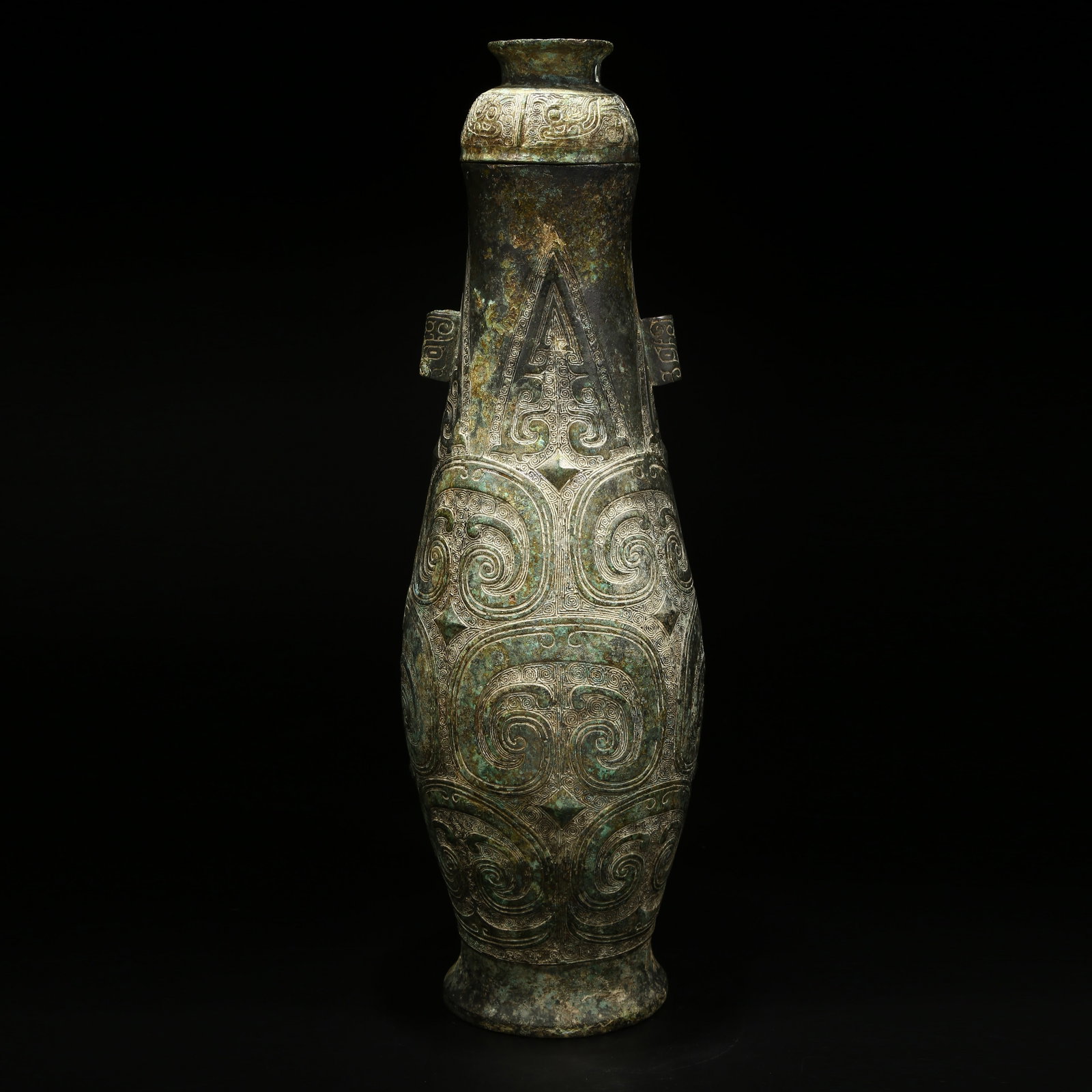 A BRONZE VASE WITH CLOUD-AND-THUNDER PATTERN AND LOOPED EARS: Bronze vase with cloud-and-thunder pattern and looped ears