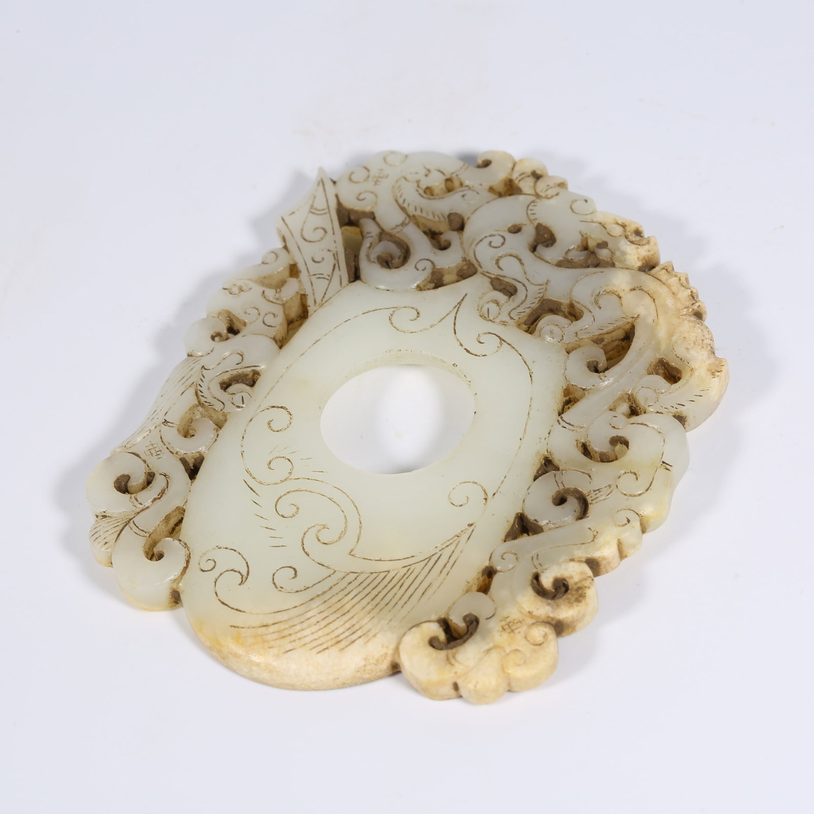 A ANCIENT JADE CHICKEN-HEART PENDANT WITH CHI-DRAGON MOTIF: Ancient Jade Chicken-Heart Pendant with Chi-Dragon Motif