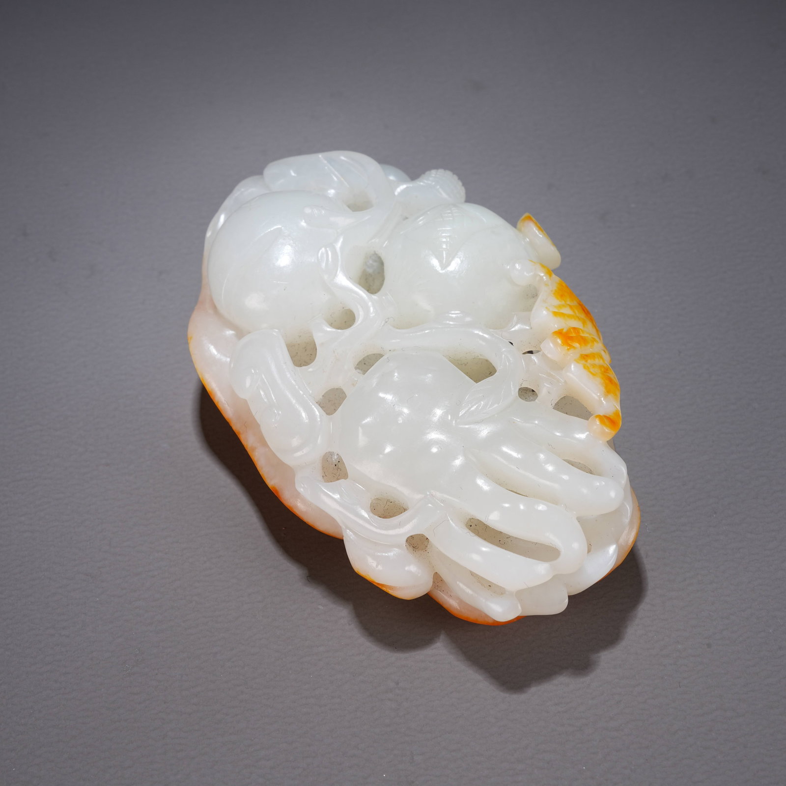 A HETIAN JADE HANDHELD ORNAMENT WITH "THREE ABUNDANCES" MOTIF: Hetian Jade Handheld Ornament with "Three Abundances" Motif