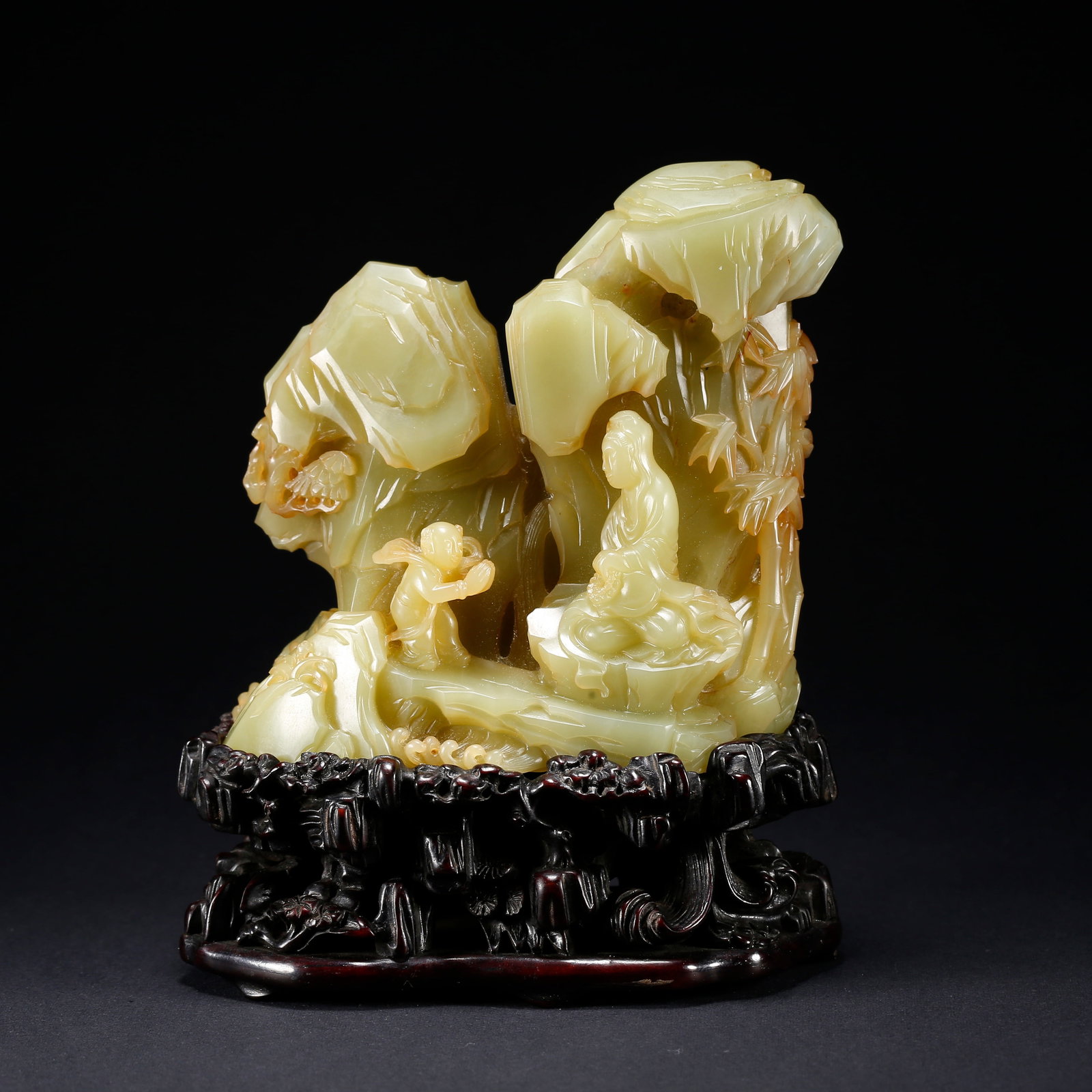 A HETIAN YELLOW JADE MINIATURE GUANYIN ON MOUNTAIN FIGURINE: Hetian Yellow Jade Miniature Guanyin on Mountain Figurine