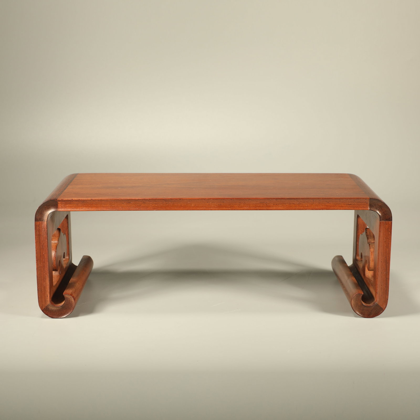 A HUANGHUALI TABLE STAND CARVED WITH GANODERMA PATTERN: Huanghuali Table Stand Carved with Ganoderma Pattern