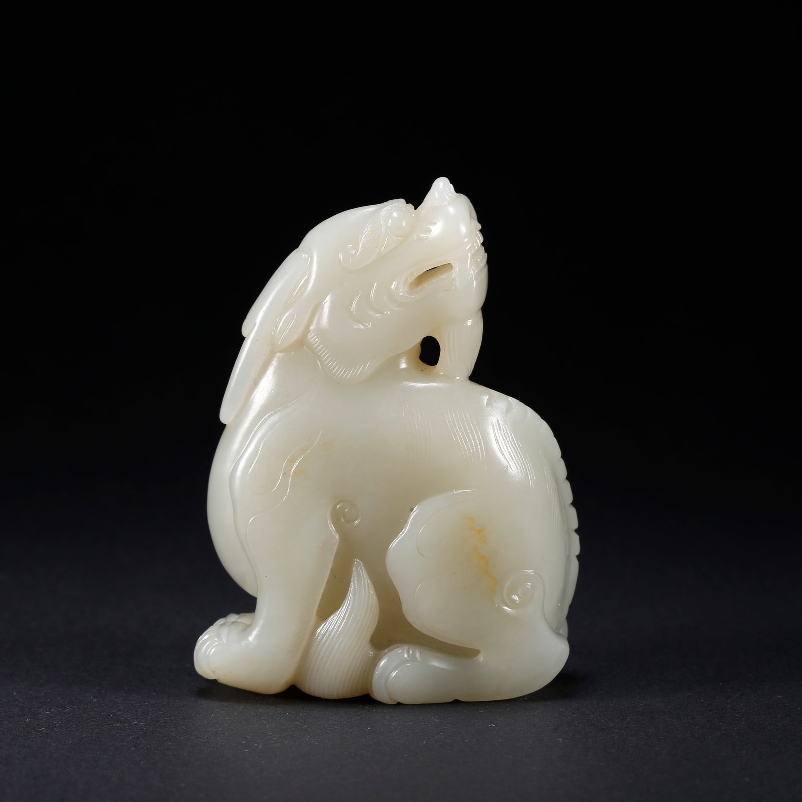 A HETIAN JADE LION-SHAPED FIGURINE: Hetian Jade Lion-Shaped Figurine