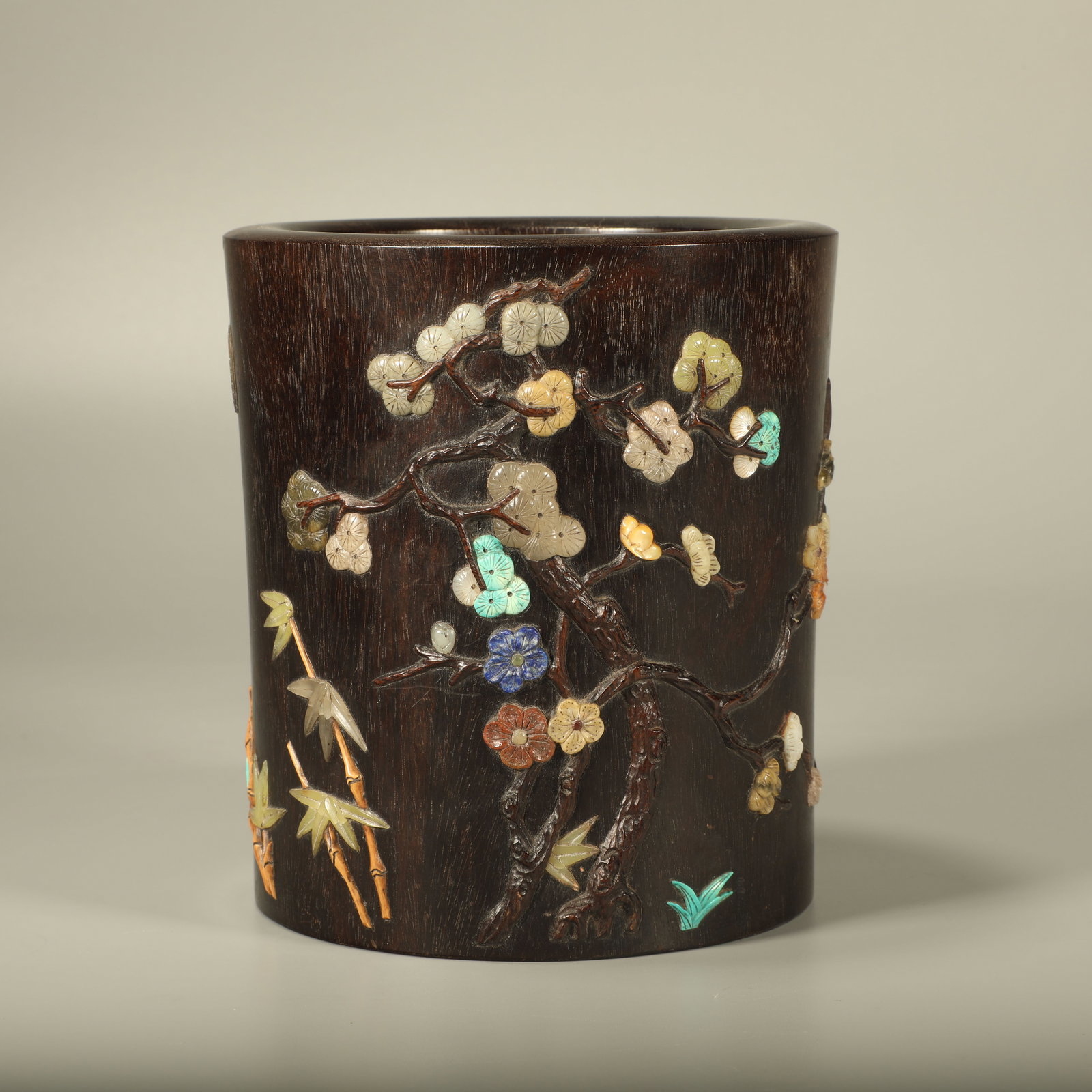 A ROSEWOOD BRUSH POT INLAID WITH PRECIOUS STONES AND CARVED WITH PINE, BAMBOO AND PLUM (1 of 6)