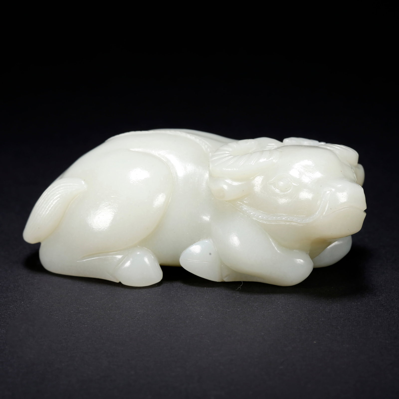 A HETIAN JADE OX-SHAPED FIGURINE (1 of 9)
