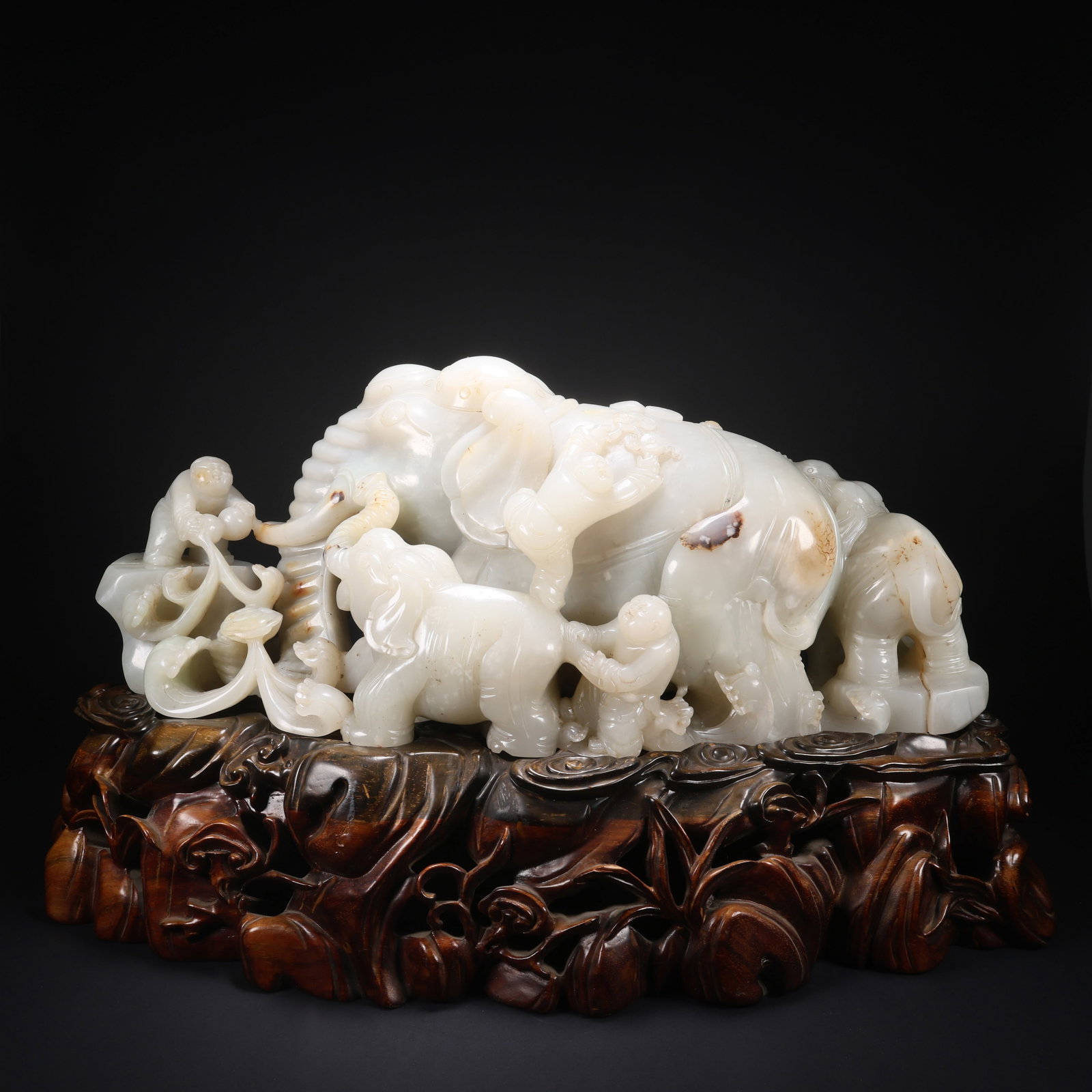 A HETIAN JADE ON WOODEN BASE, BOY PLAYING WITH ELEPHANT FIGURINE (1 of 9)