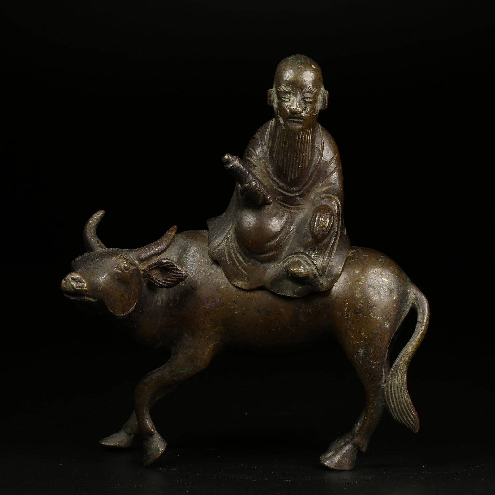 A BRONZE FIGURINE OF LAOZI RIDING AN OX (1 of 9)