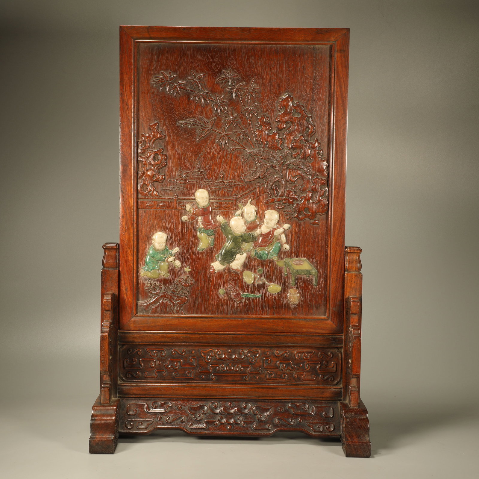 A HUANGHUALI TABLE SCREEN INLAID WITH HUNDRED TREASURES AND CHILDREN AT PLAY FIGURES: Huanghuali Table Screen Inlaid with Hundred Treasures and Children at Play Figures