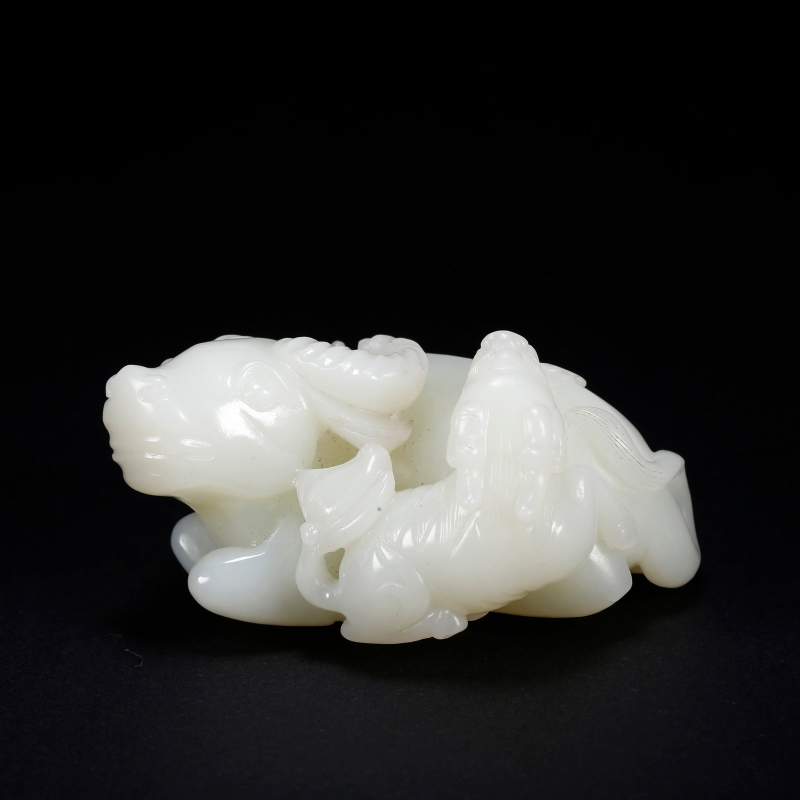 A HETIAN JADE BEAST-SHAPED FIGURINE (1 of 9)
