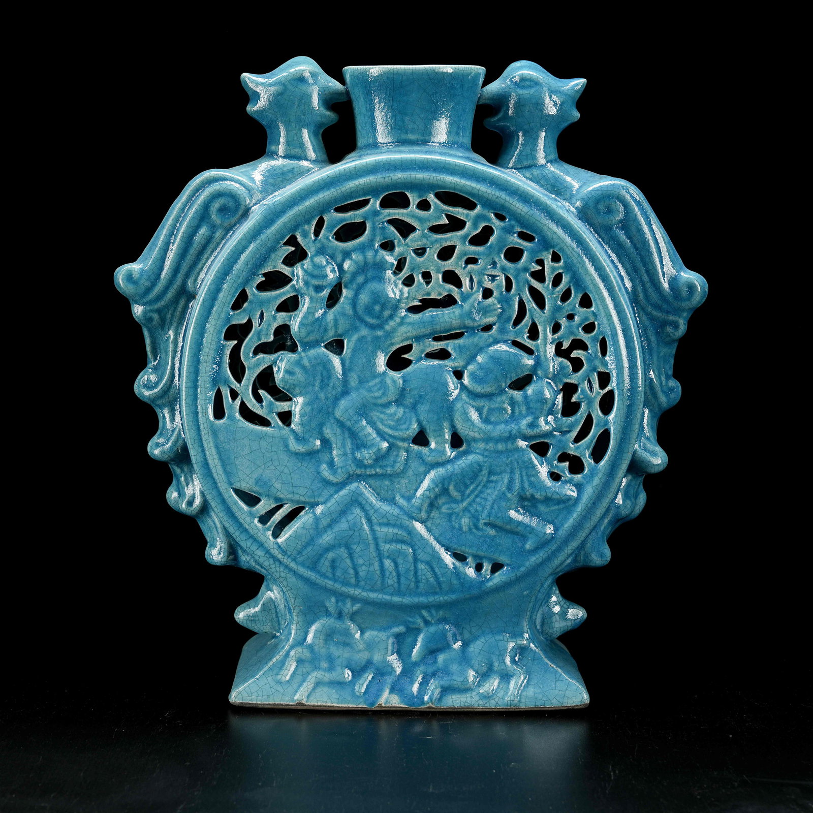 A OPENWORK BLUE GLAZED MOON FLASK WITH DOUBLE PHOENIX AND FOREIGN FIGURE PLAYING LION MOTIF: Openwork Blue Glazed Moon Flask with Double Phoenix and Foreign Figure Playing Lion Motif