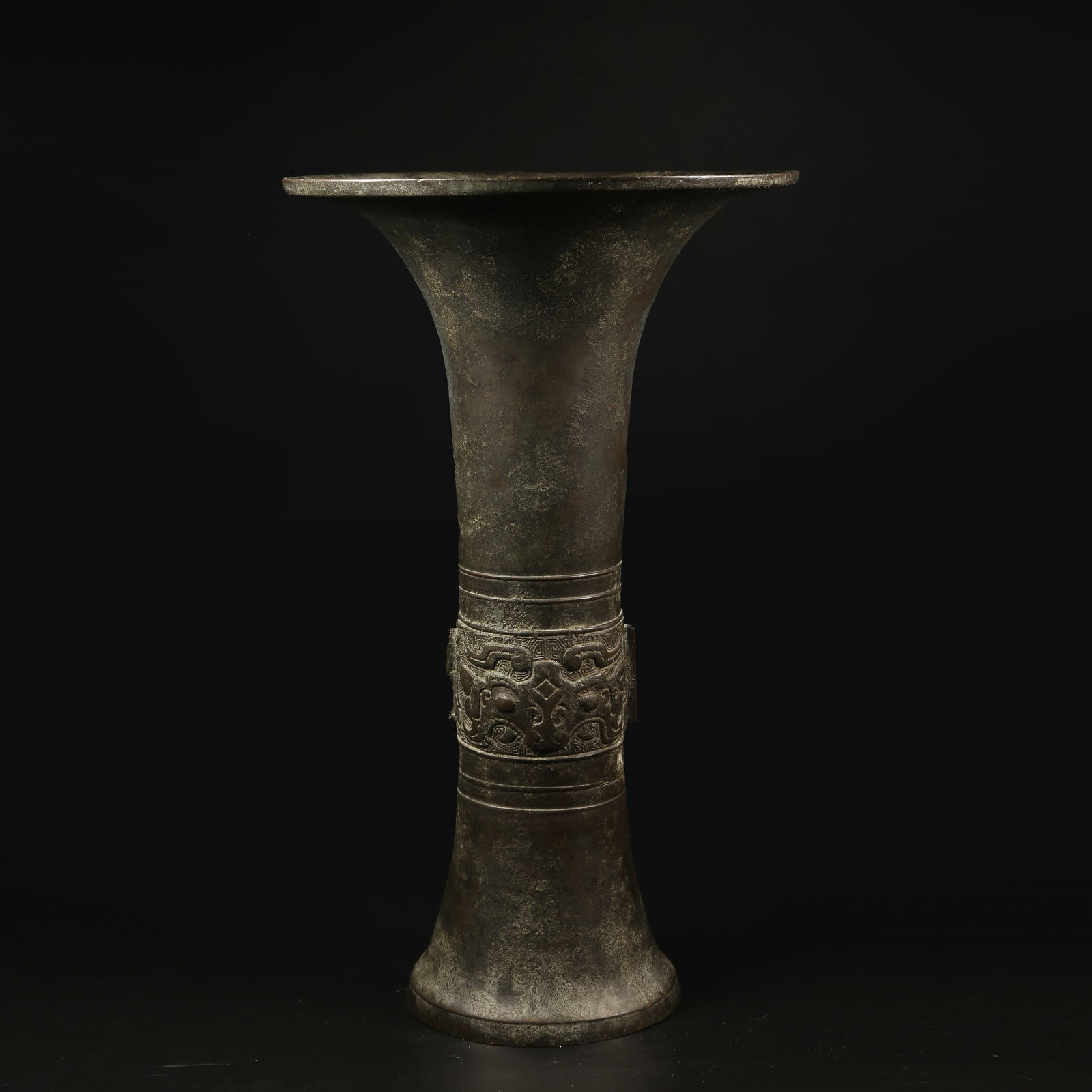 A BRONZE TRIPOD HU WITH TAOTIE MASK DESIGN: Bronze Tripod Hu with Taotie Mask Design