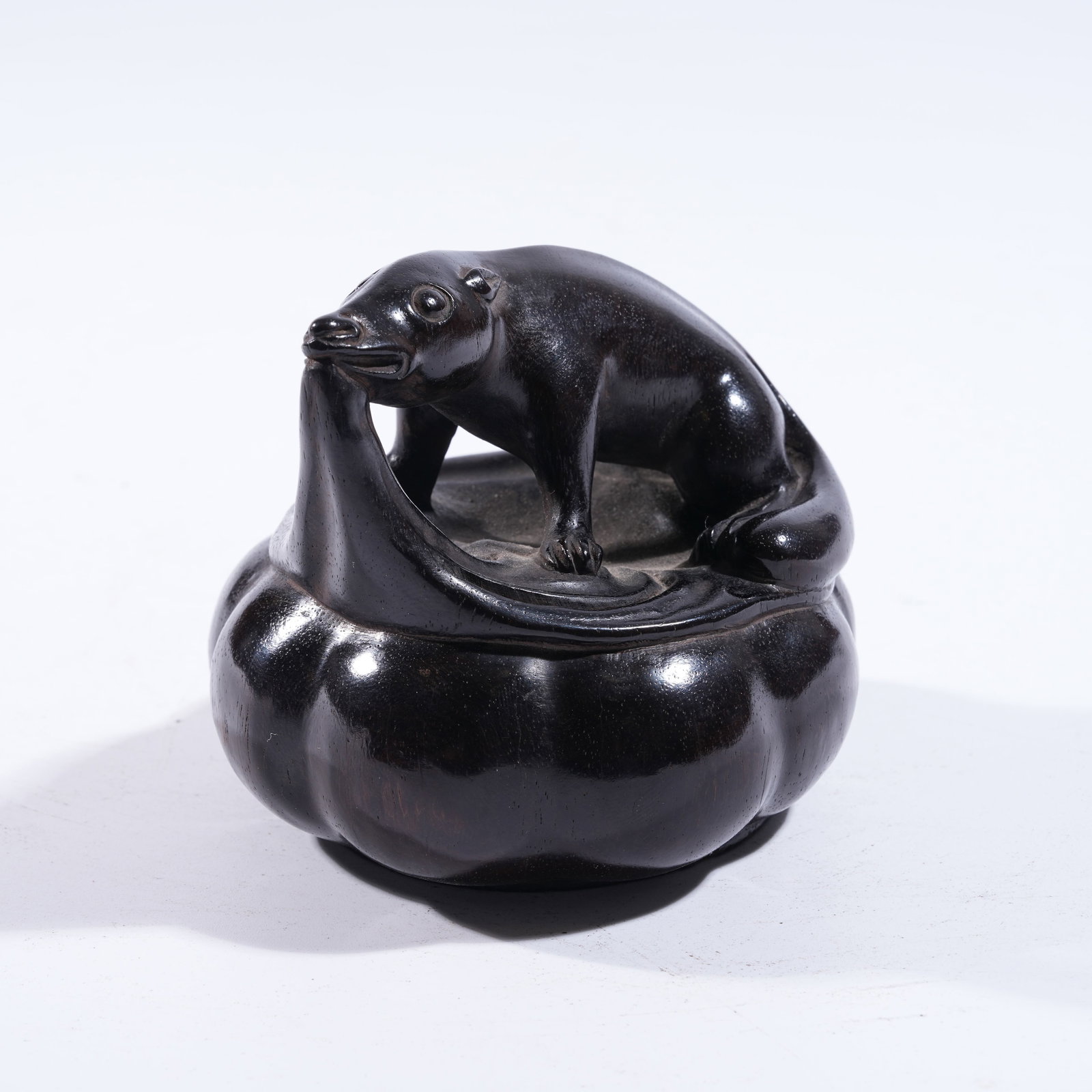 A AUSPICIOUS BEAST ORNAMENT IN ZITAN WOOD: Auspicious Beast Ornament in Zitan Wood