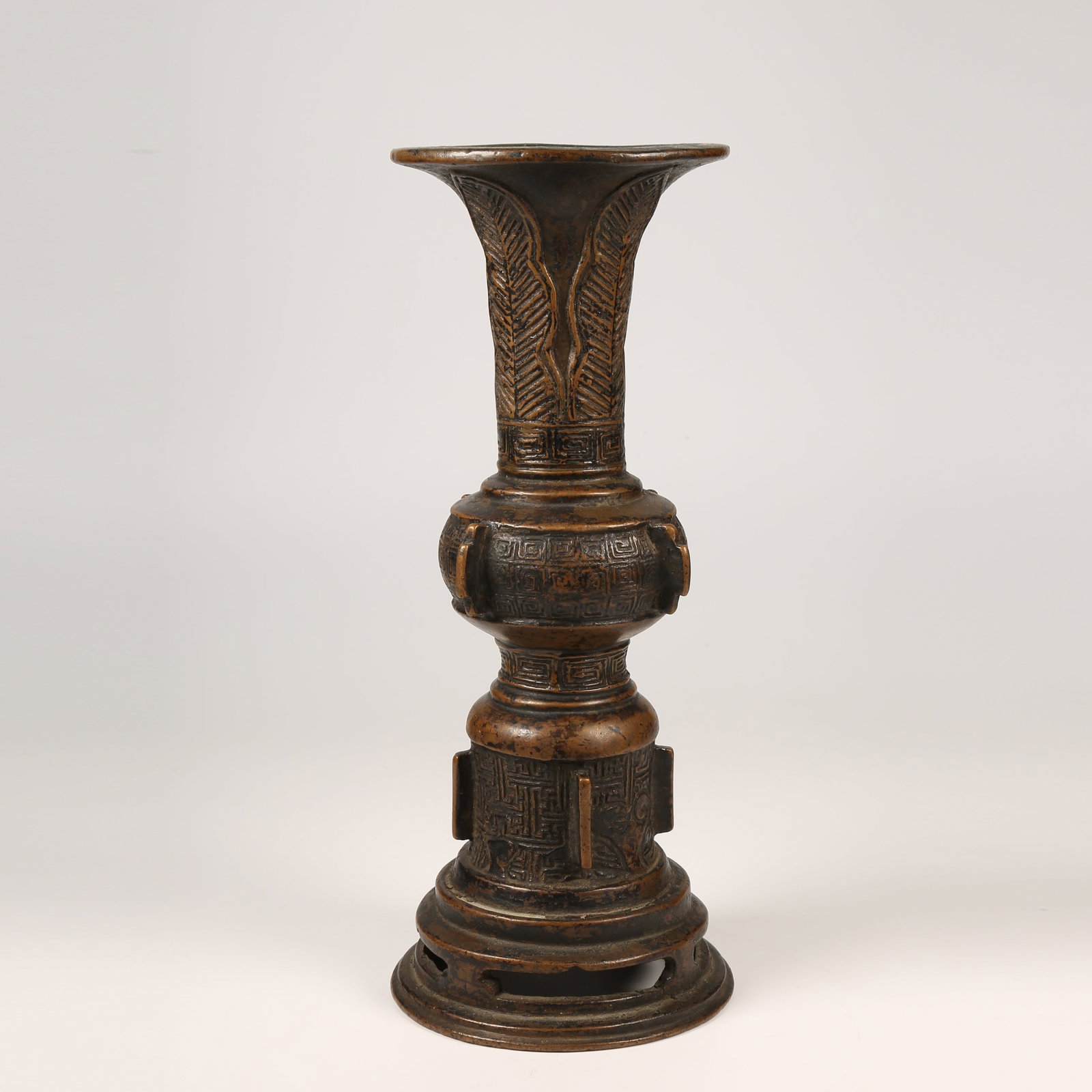 A BRONZE GU VESSEL WITH UPRIGHT FINIALS AND KEY-FRET PATTERN: Bronze Gu Vessel with Upright Finials and Key-Fret Pattern