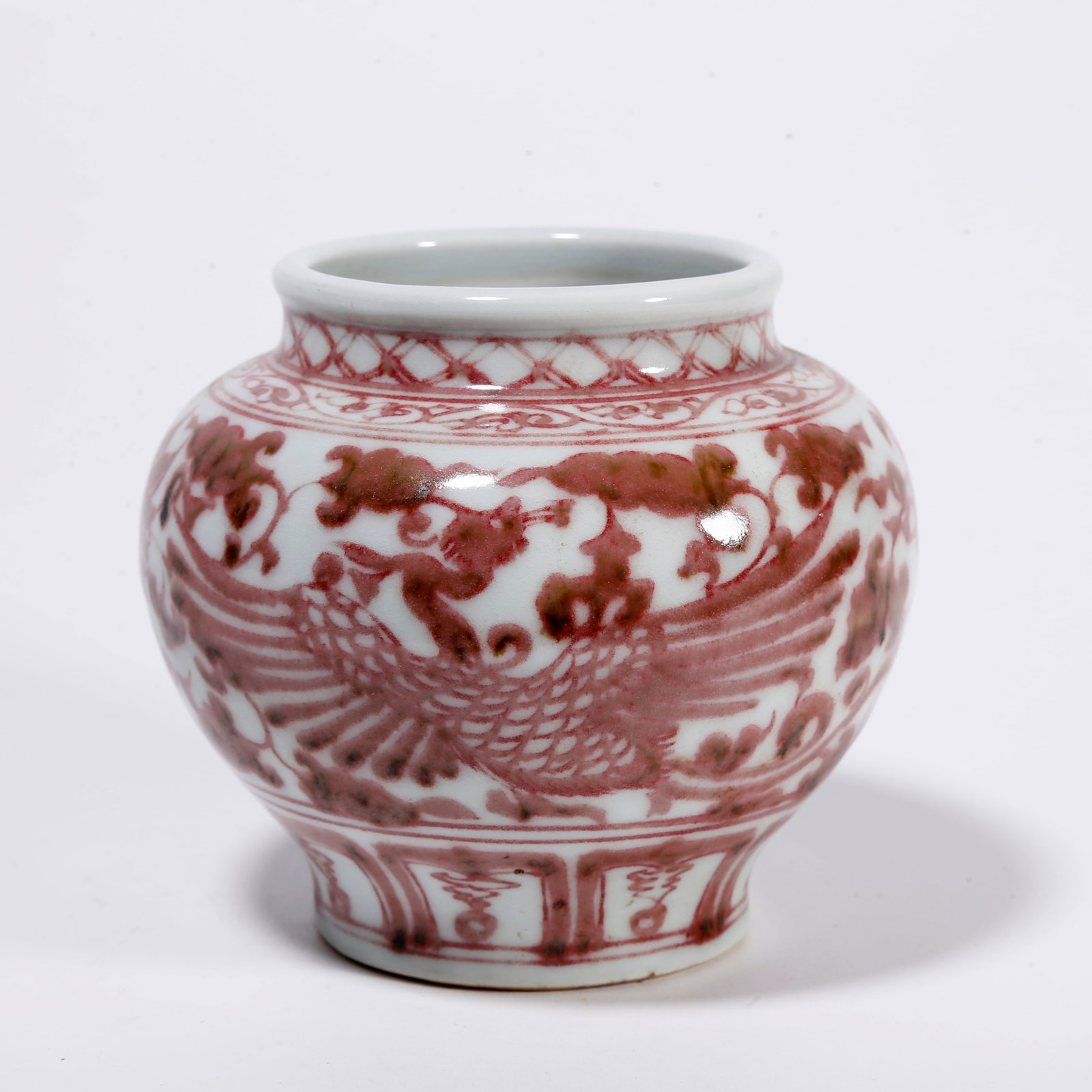 A IRON-RED JAR WITH PHOENIX AMIDST FLORAL PATTERN: Iron-red Jar with Phoenix Amidst Floral Pattern