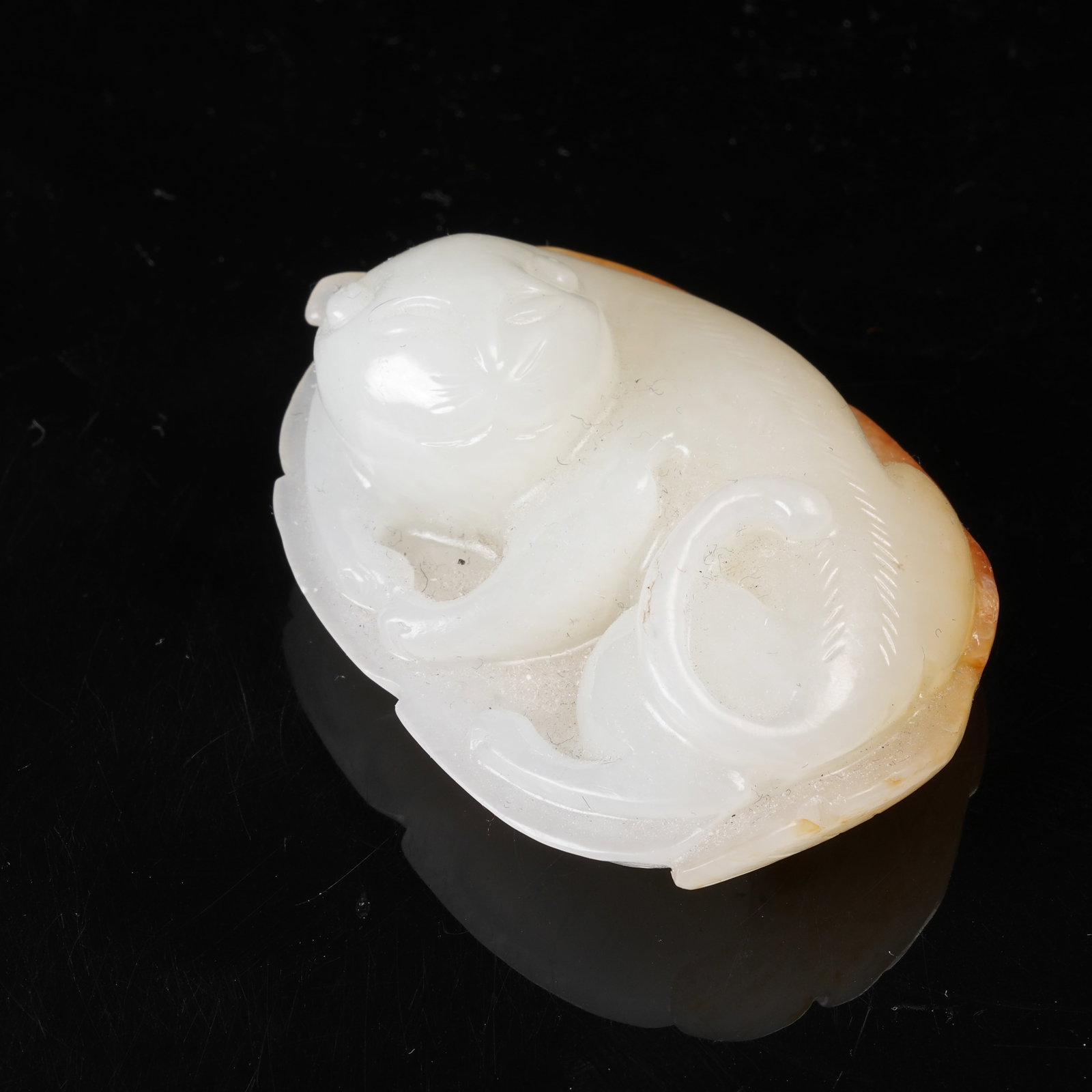 A HETIAN JADE RECUMBENT BEAST PENDANT (1 of 8)