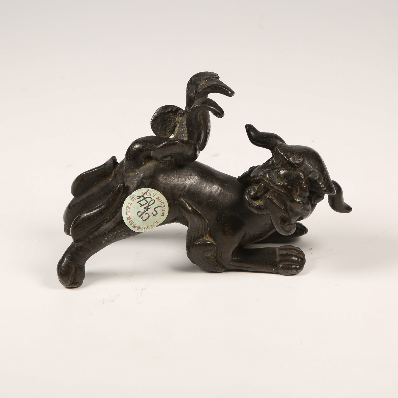 A BRONZE LION FIGURINE: Bronze Lion Figurine