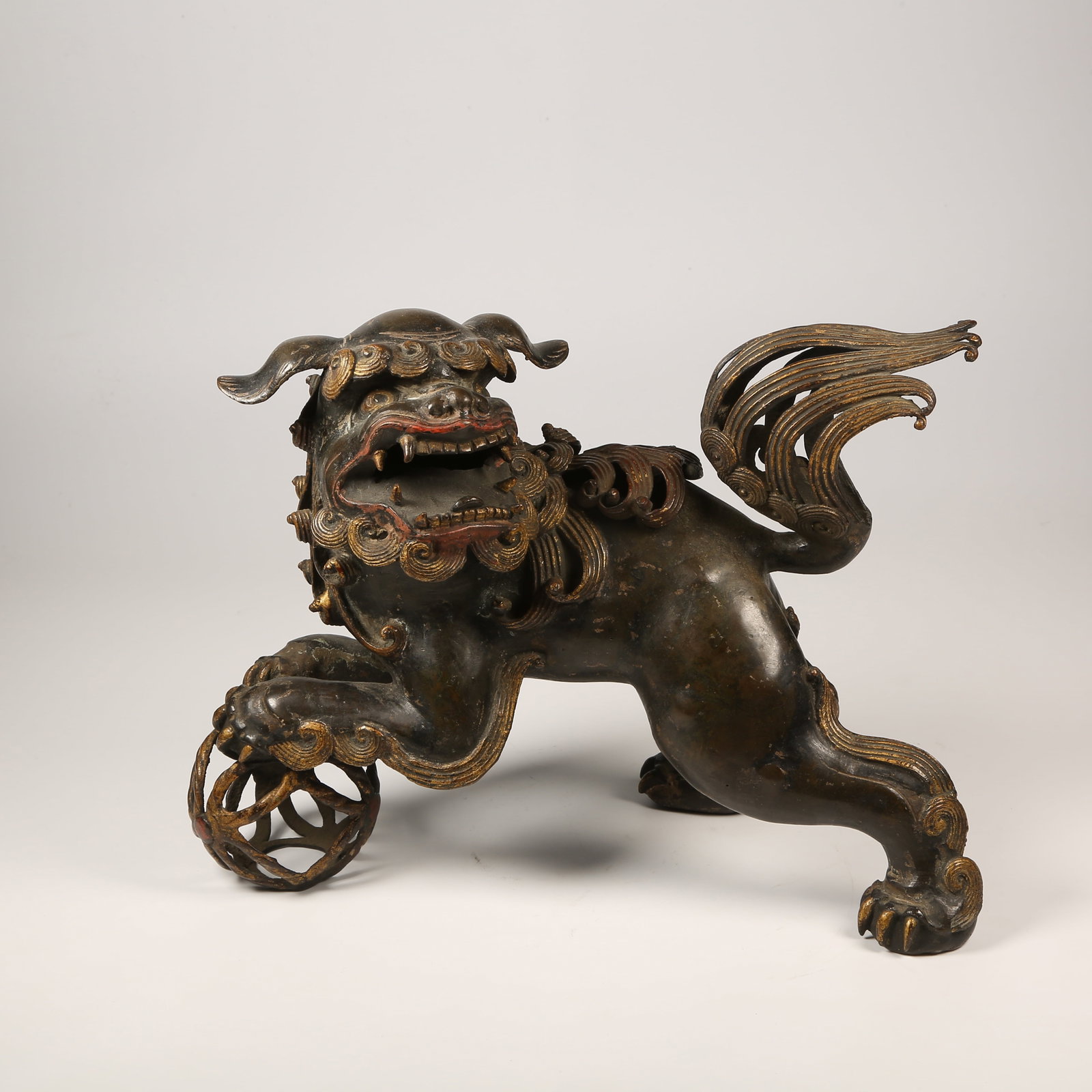 A BRONZE LION PLAYING WITH BALL CENSER: Bronze Lion Playing with Ball Censer