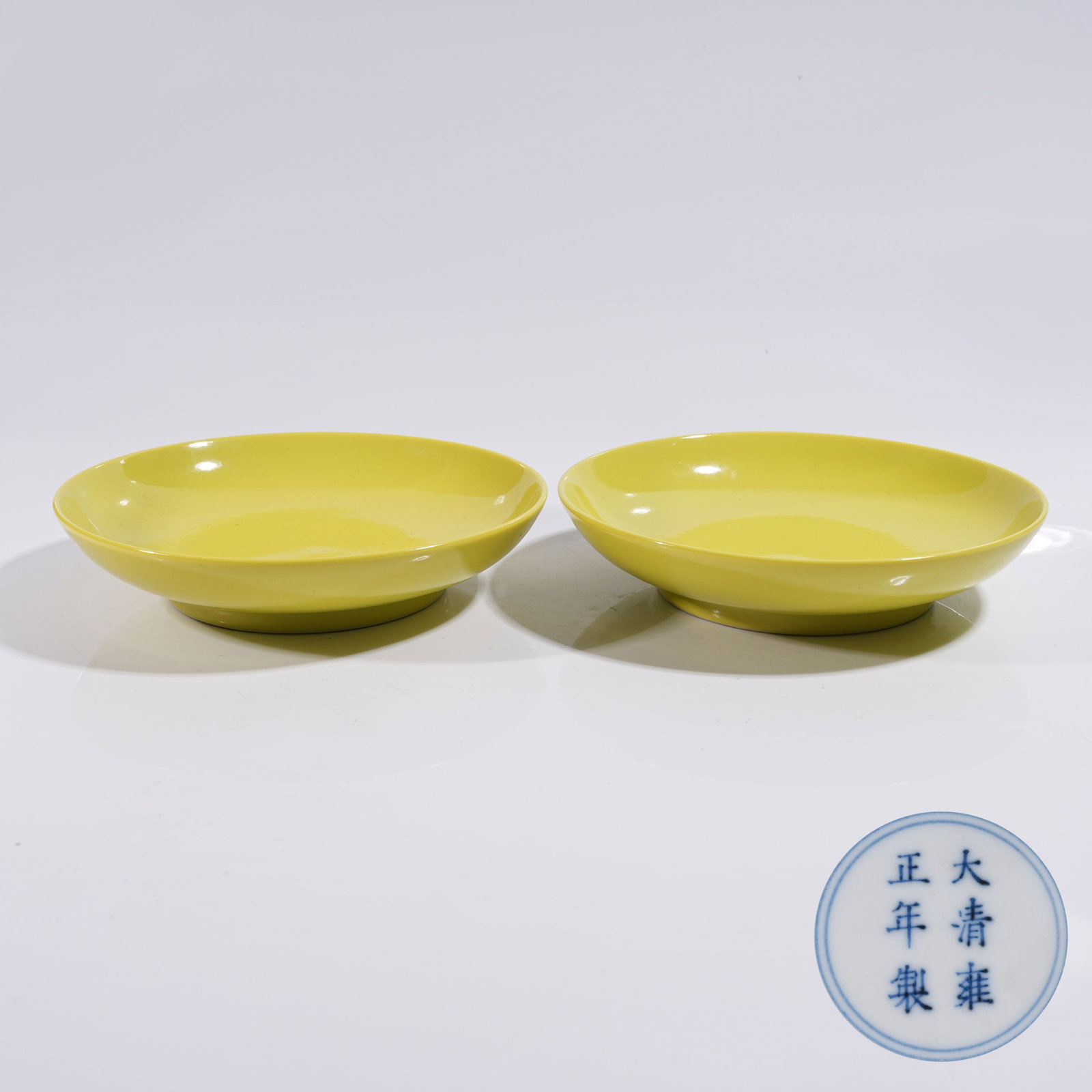 A SET OF LEMON YELLOW GLAZED PLATES: Set of Lemon Yellow Glazed Plates