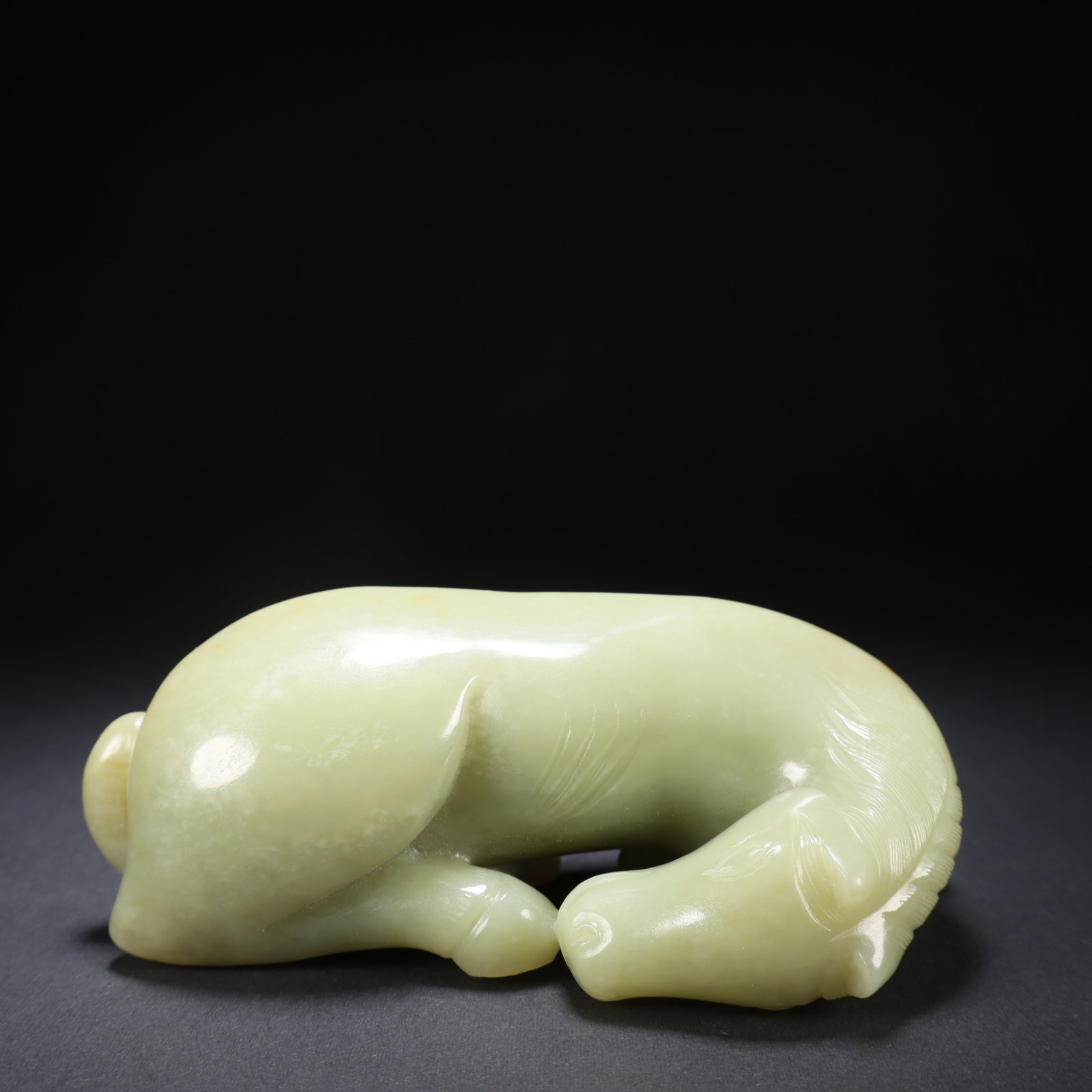 A HETIAN JADE CURVED-HEAD LYING HORSE (1 of 9)