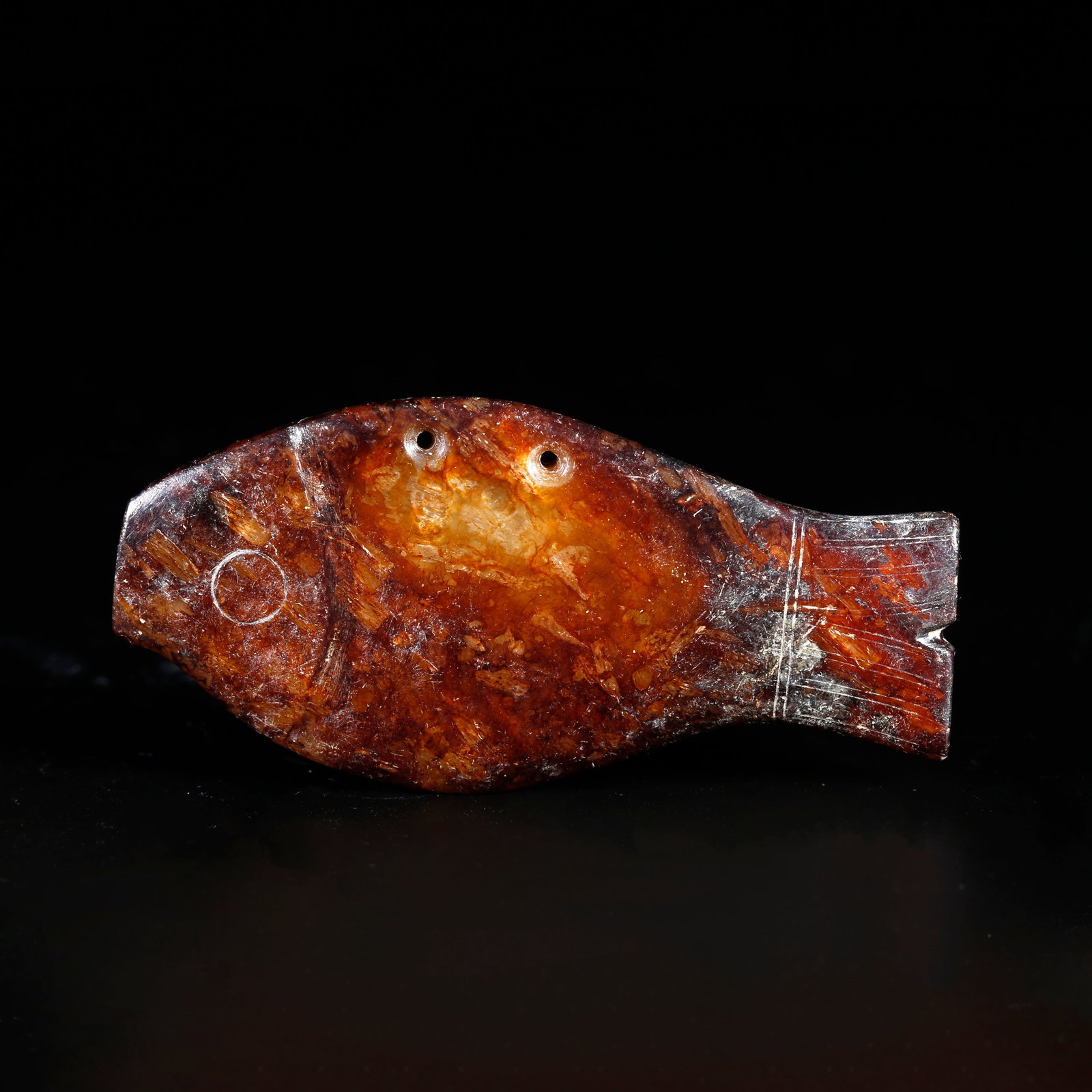 A ARCHAIC JADE CARVING OF A FISH-SHAPED PENDANT: Archaic jade carving of a fish-shaped pendant
