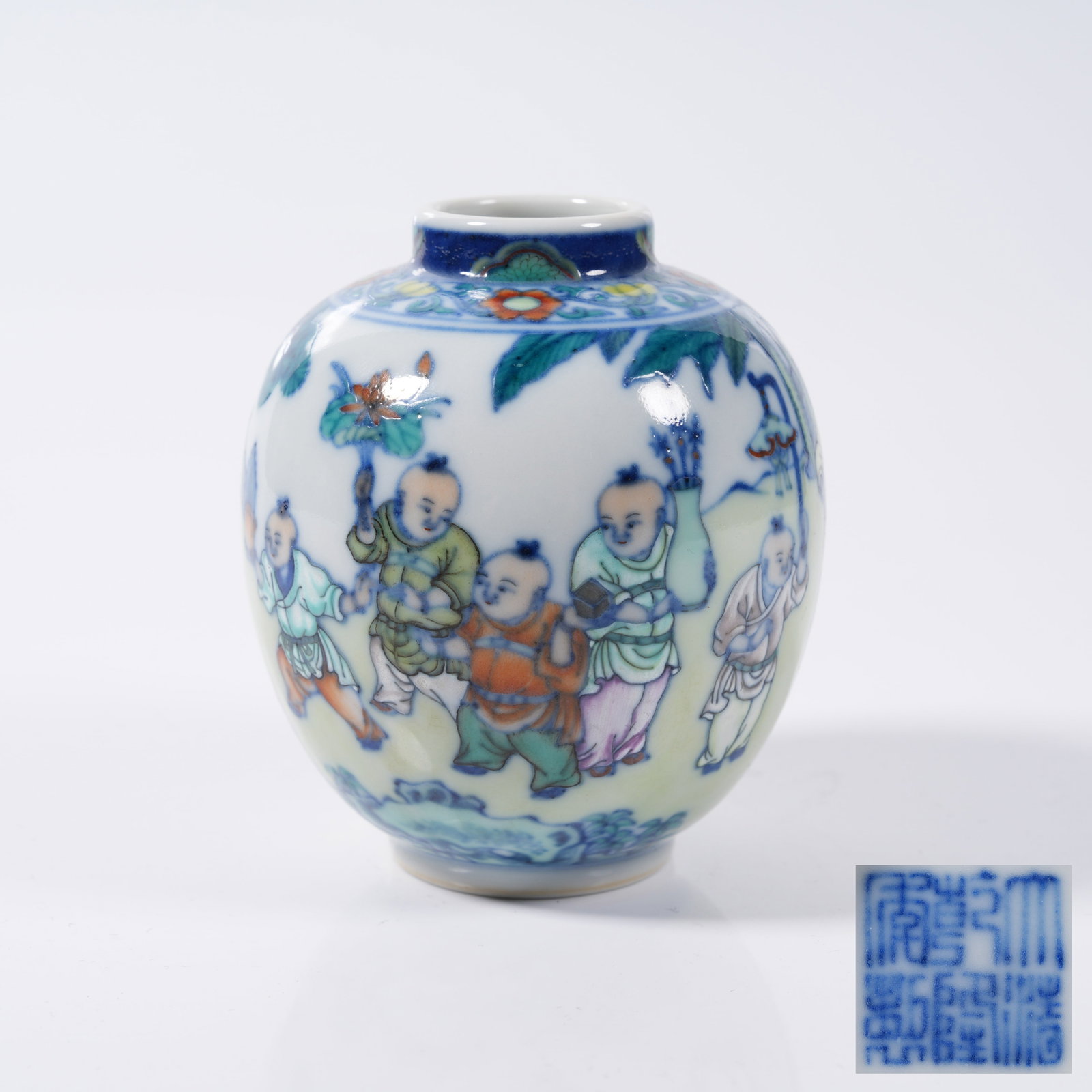 A DOUCAI SMALL JAR WITH COURTYARD CHILDREN PLAYING PATTERN: Doucai Small Jar with Courtyard Children Playing Pattern