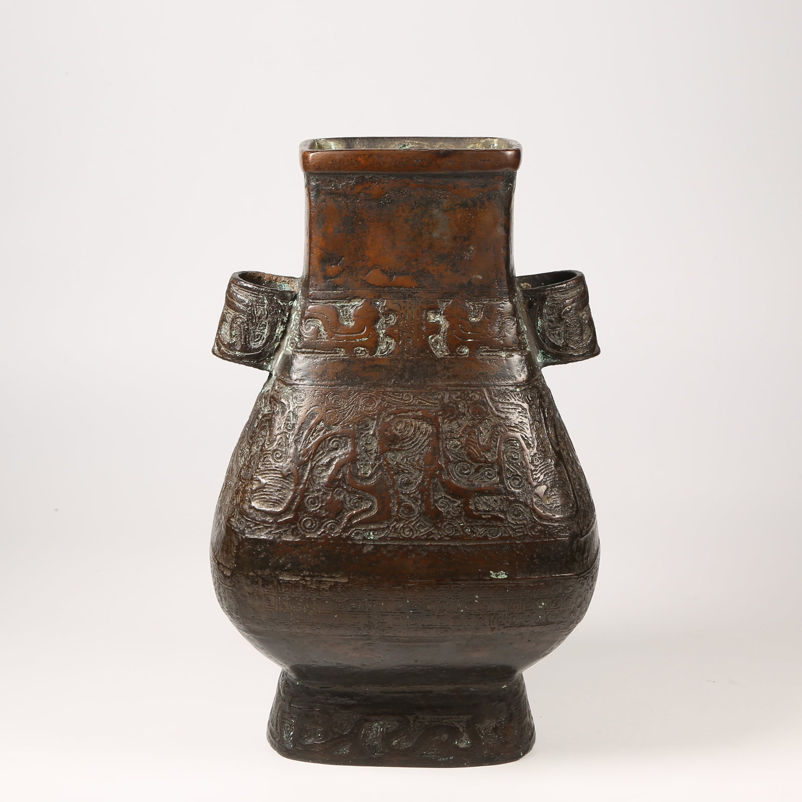 A BRONZE VASE WITH ANIMAL-FORM HANDLES AND DECORATIVE MOTIFS: Bronze Vase with Animal-Form Handles and Decorative Motifs