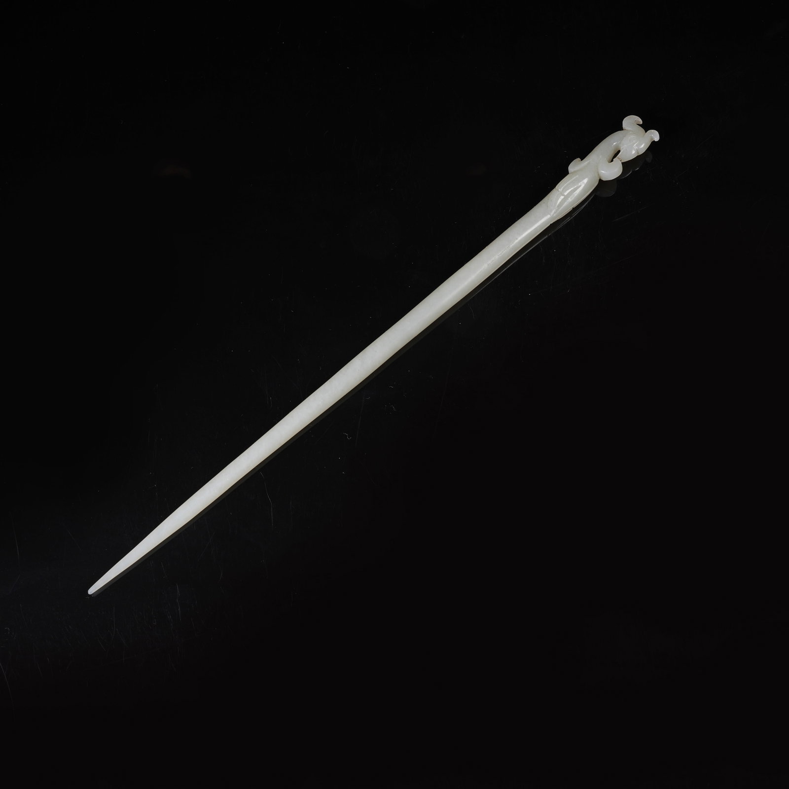 A HETIAN JADE HAIRPIN WITH PHOENIX-HEAD FINIAL: Hetian Jade Hairpin with Phoenix-Head Finial