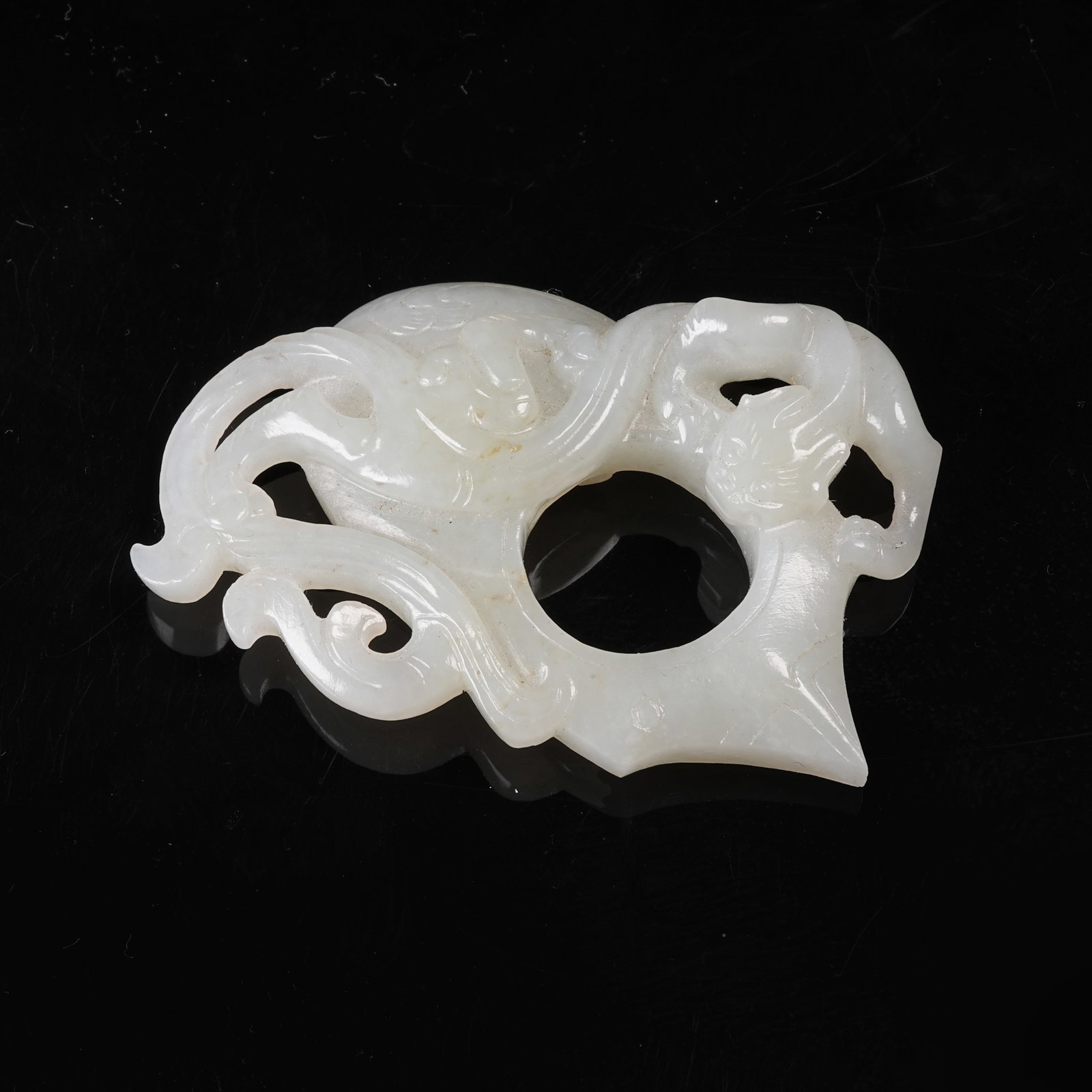 A HETIAN JADE "CHICKEN-HEART" PENDANT WITH CHI-DRAGON MOTIF (1 of 8)